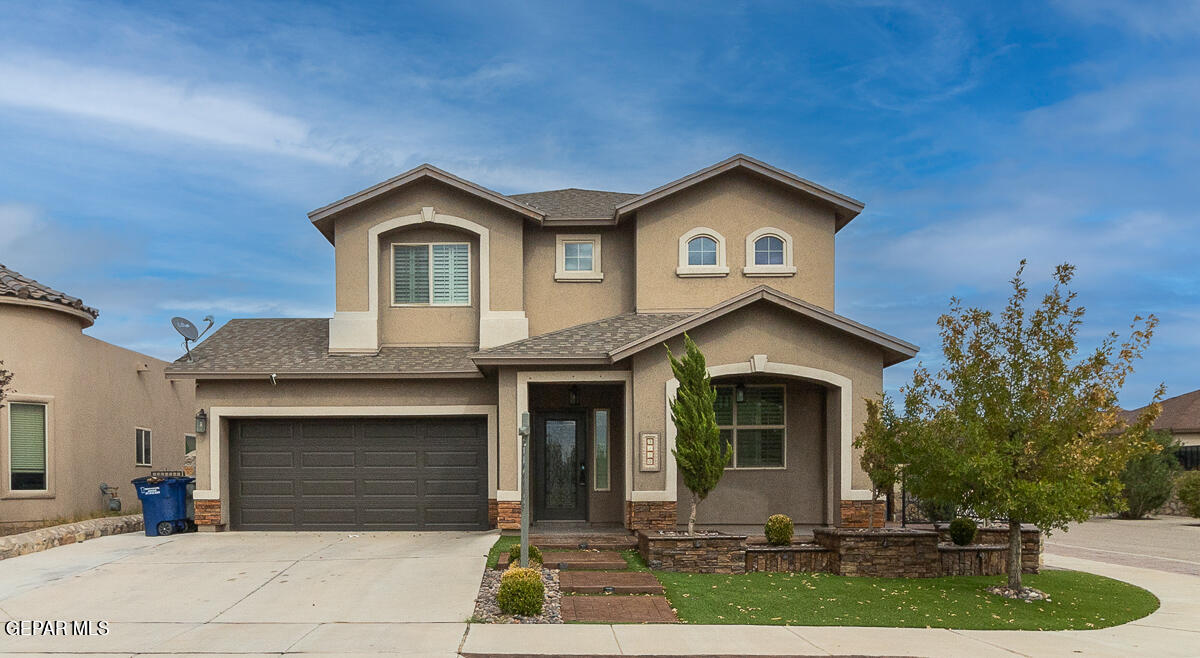 a front view of a house with a yard and garage