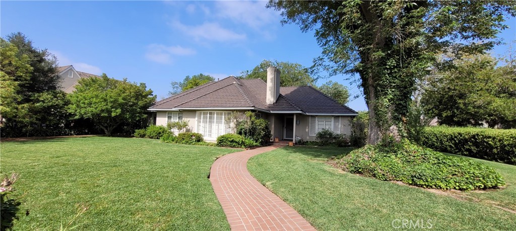 a front view of a house with yard and green space