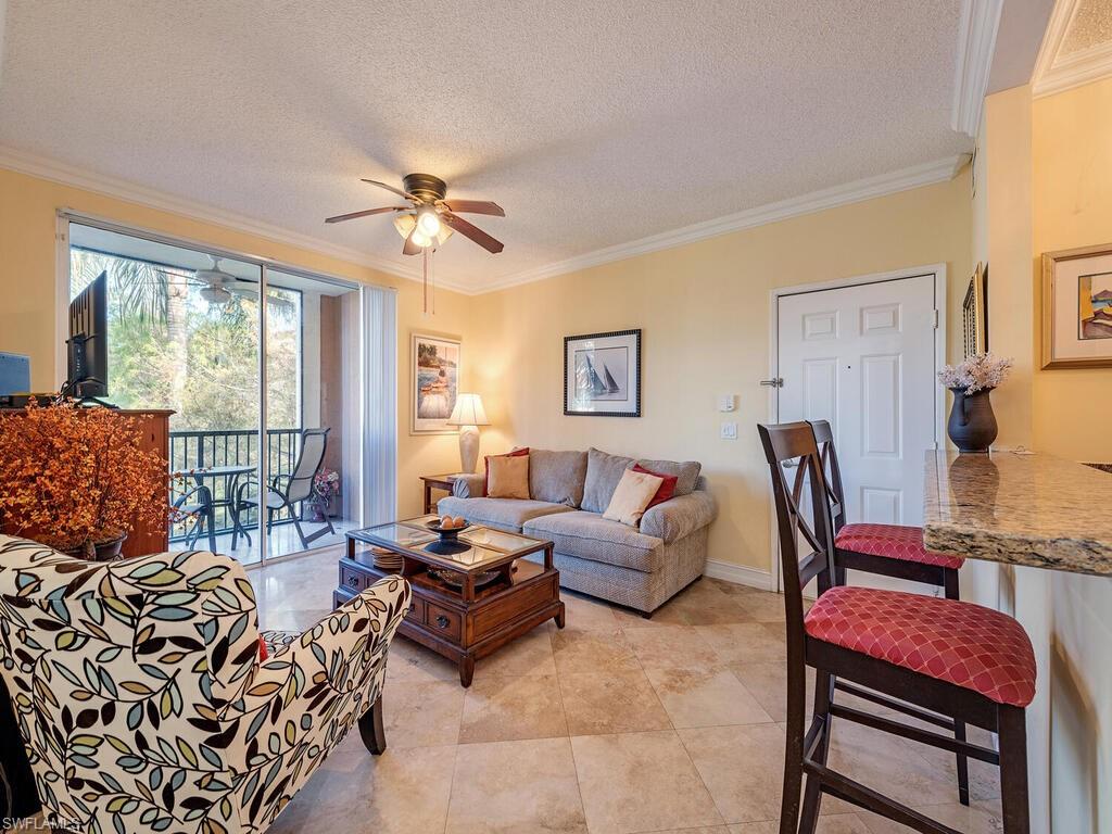 a living room with furniture or couch and a chandelier