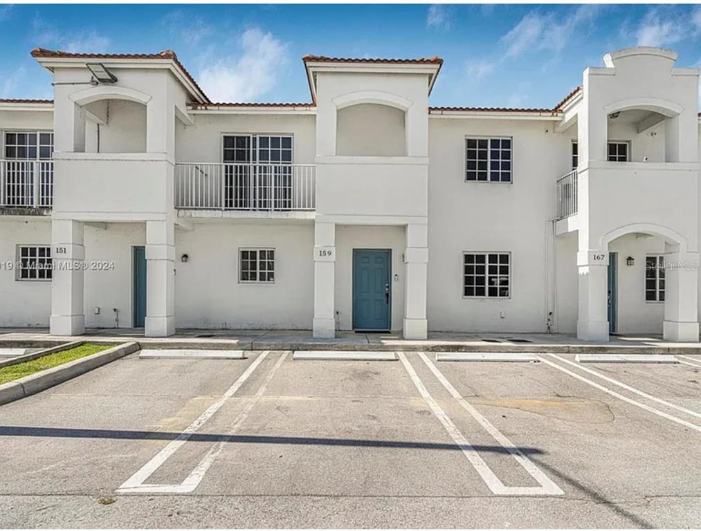 a view of a building with car parked