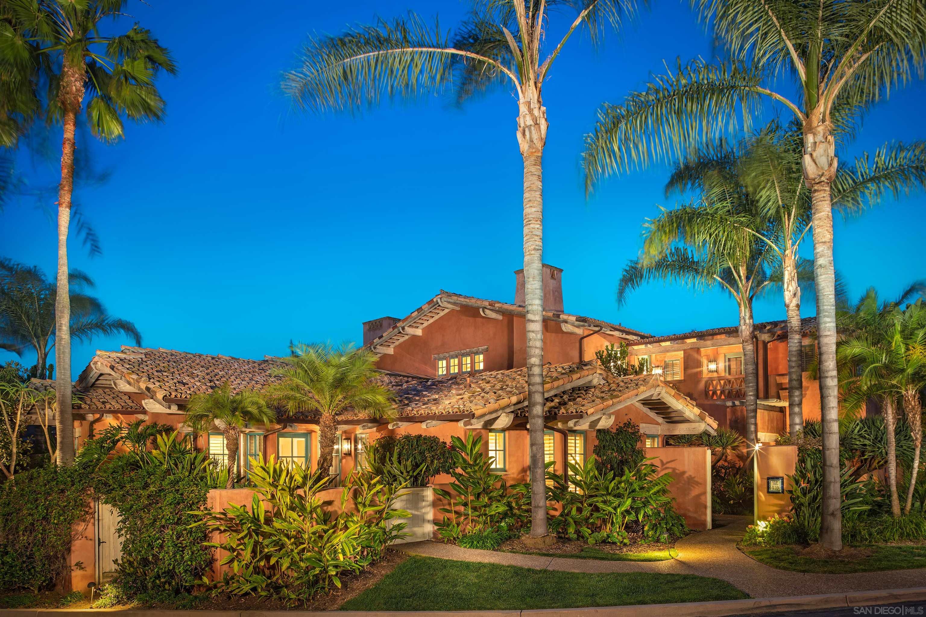 a view of a house with a yard and potted plants