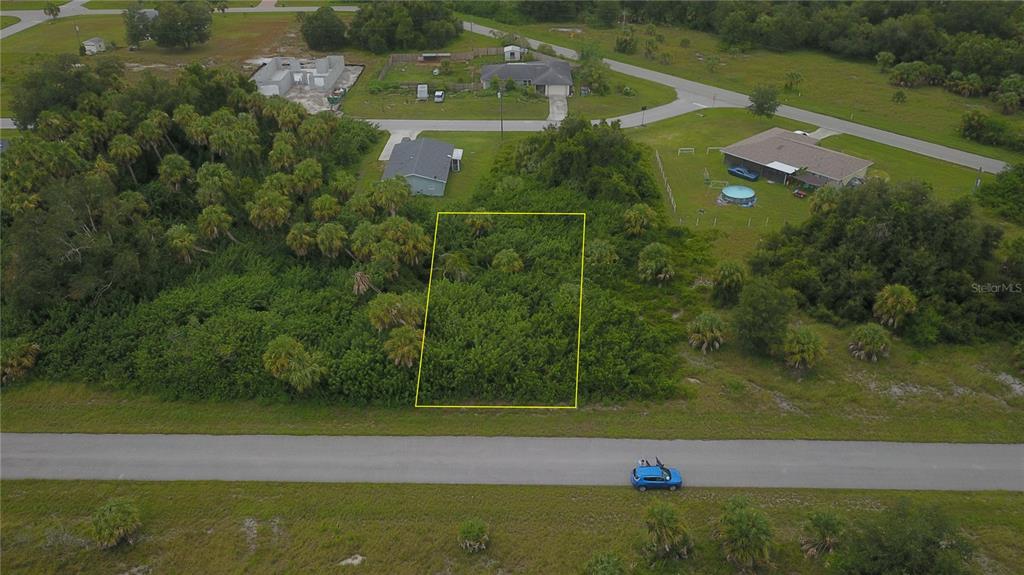 an aerial view of a houses with a yard