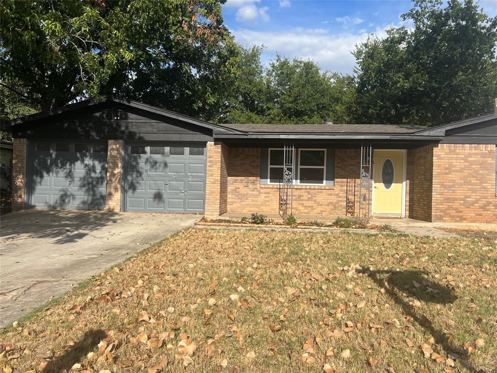 a front view of house with yard and trees around