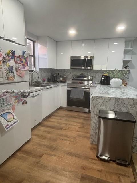 a kitchen with stainless steel appliances granite countertop a stove sink and cabinets