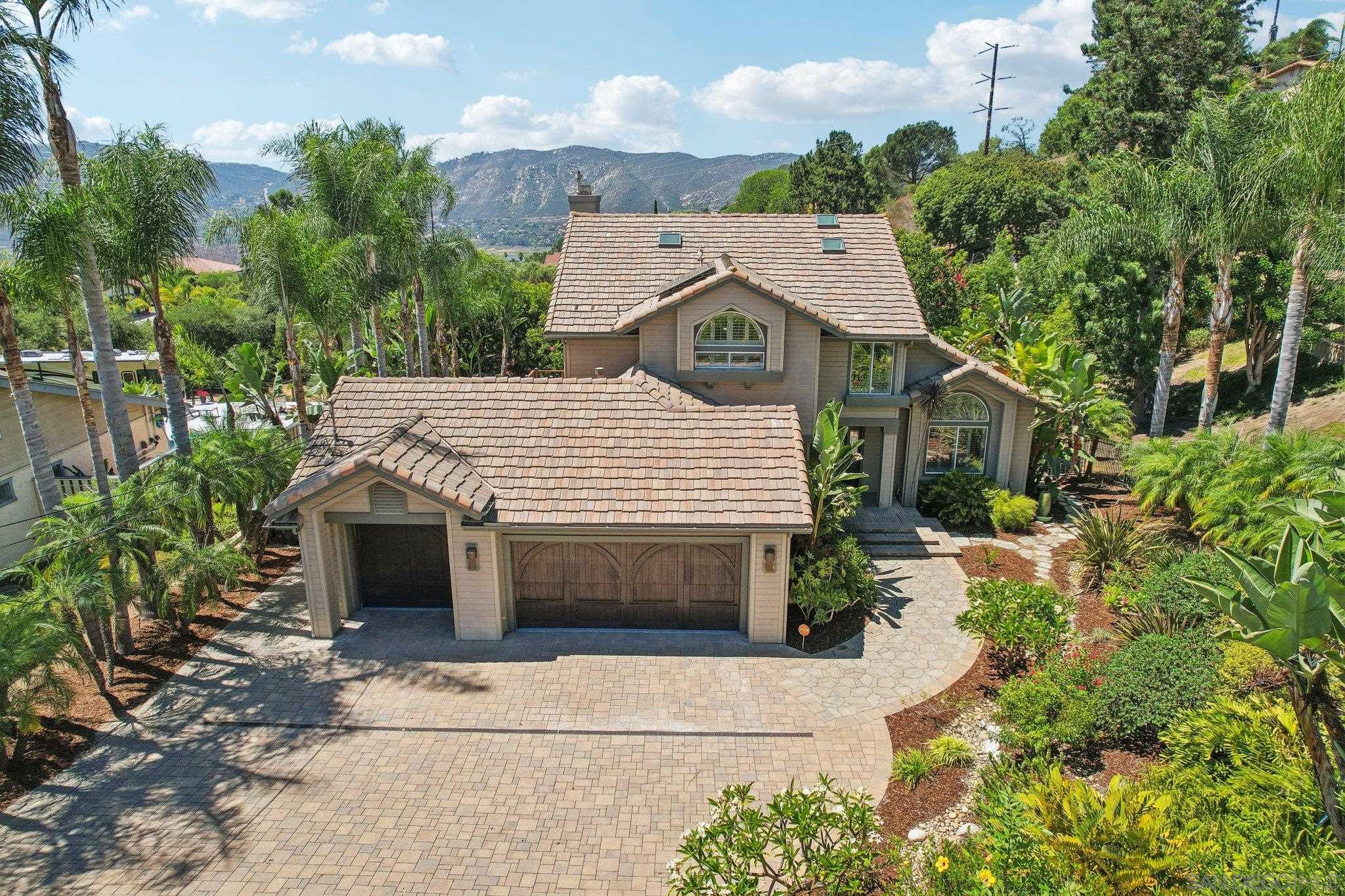 a aerial view of a house with a yard and potted plants