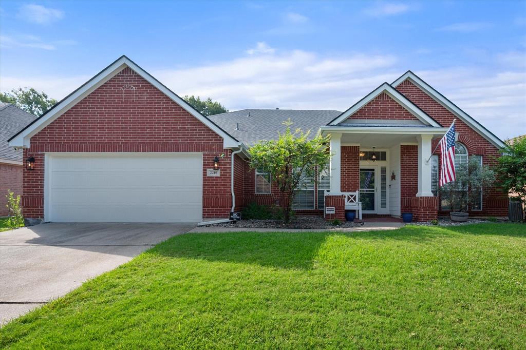 a front view of a house with a yard and porch