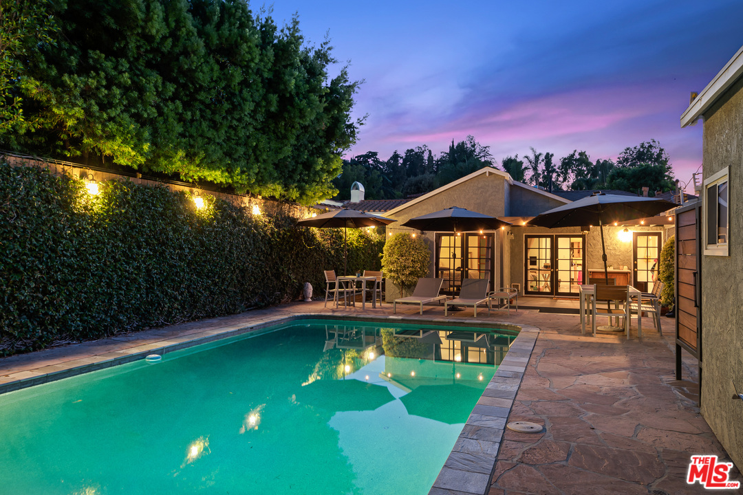 a view of a swimming pool with sitting area