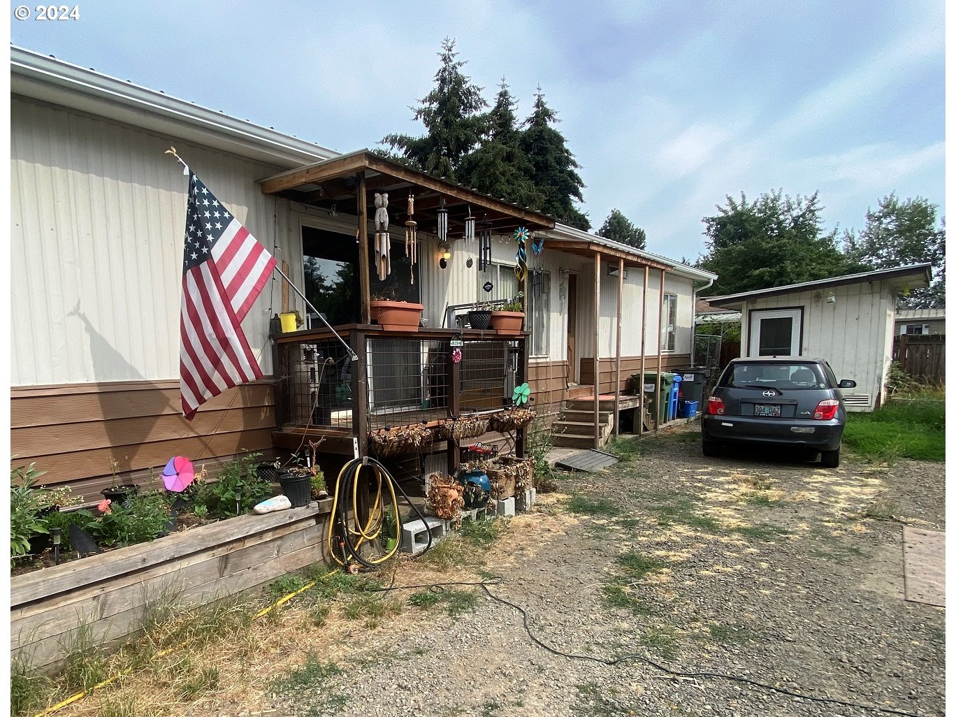 a view of a house with a patio and a yard