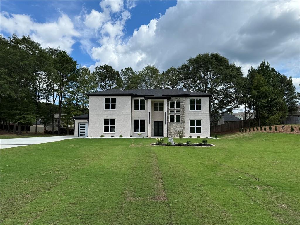 a front view of a house with a garden