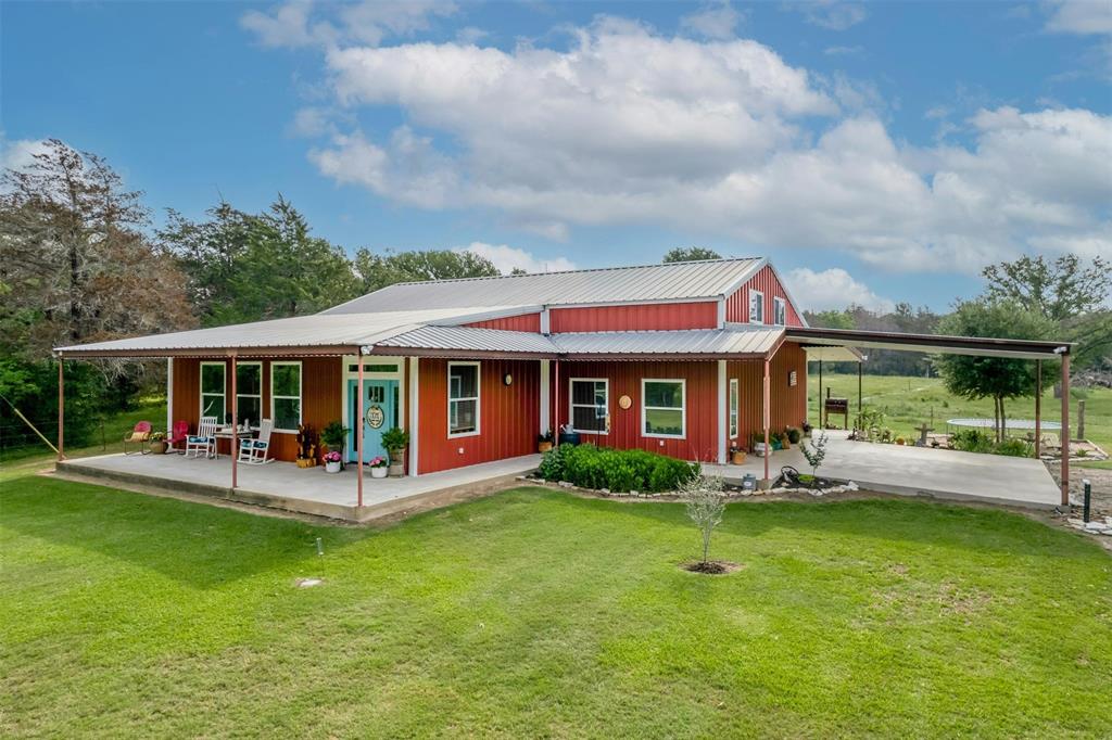 a front view of house with yard having outdoor seating