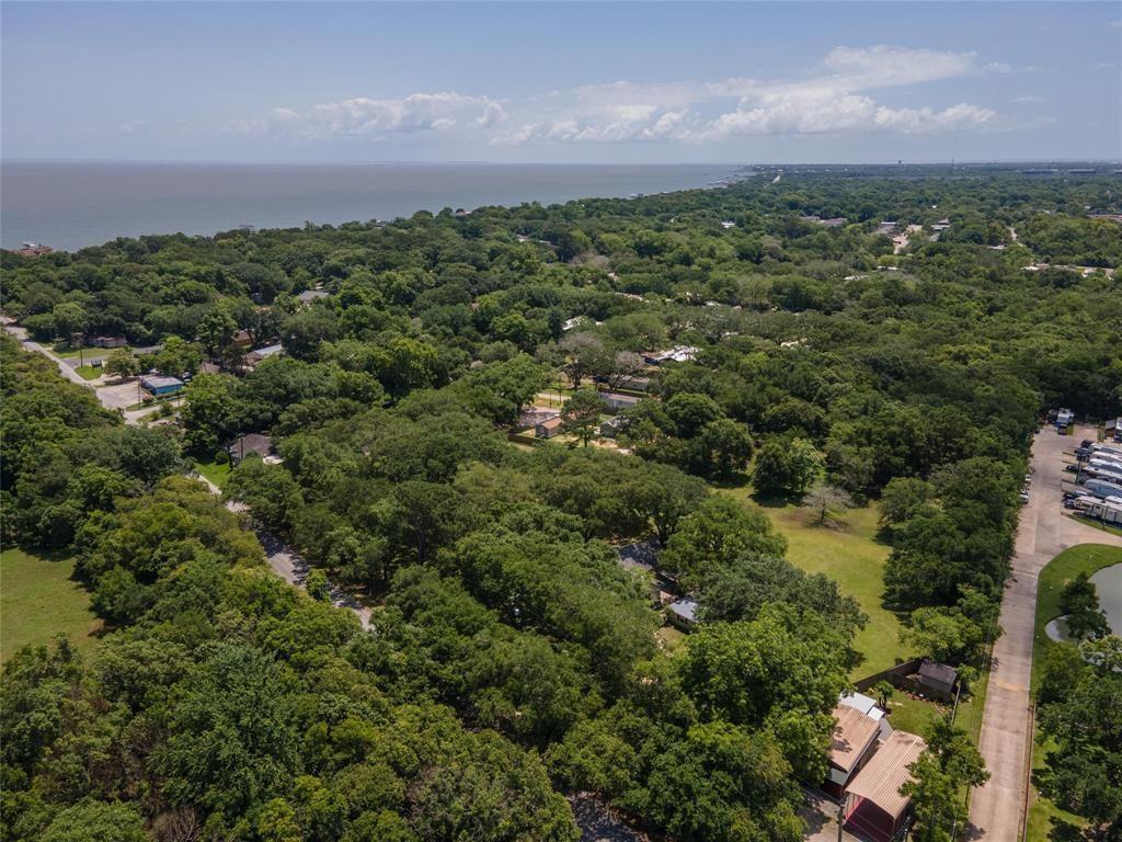 an aerial view of residential houses with outdoor space and trees