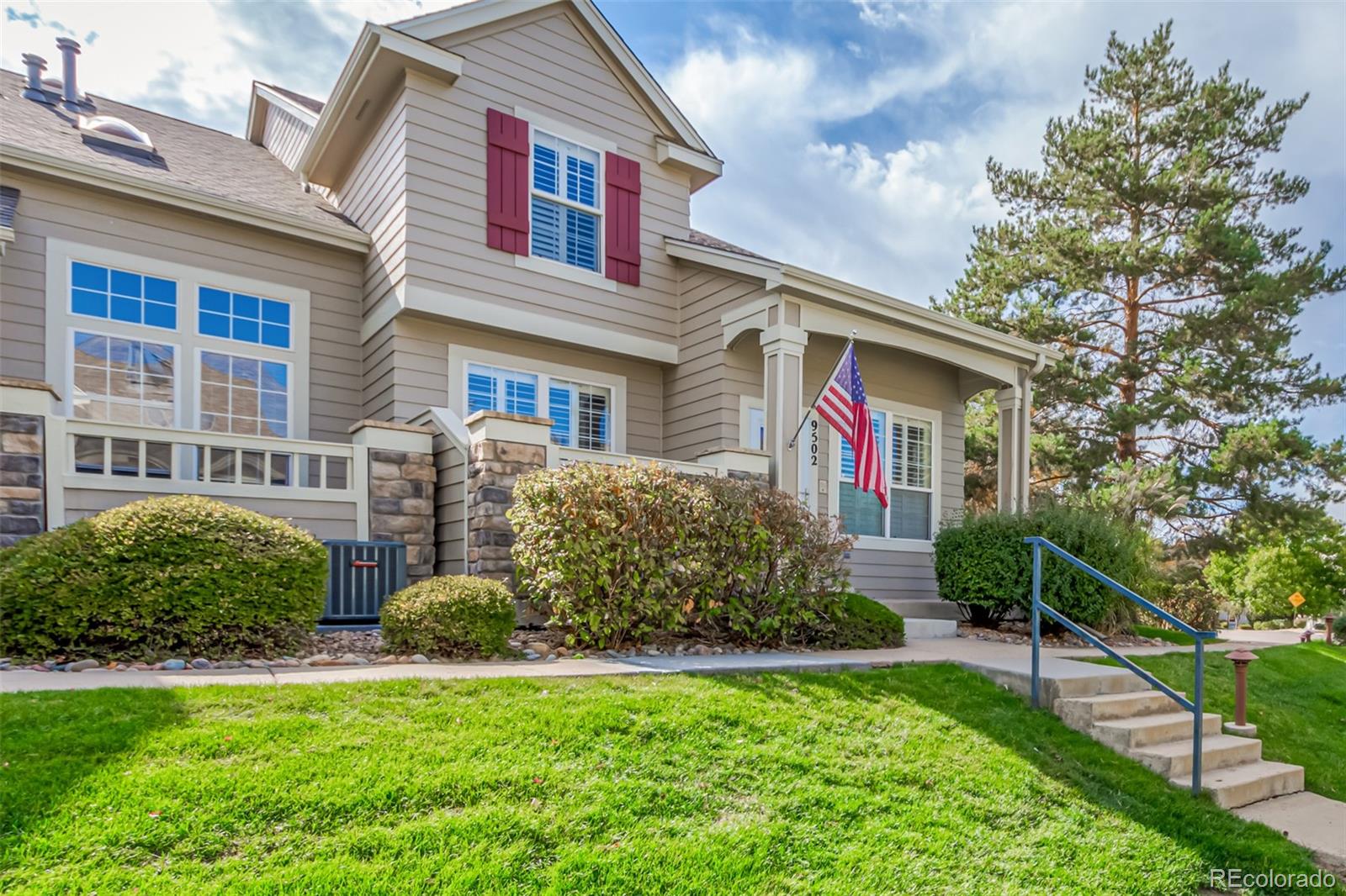 a front view of house with yard and green space