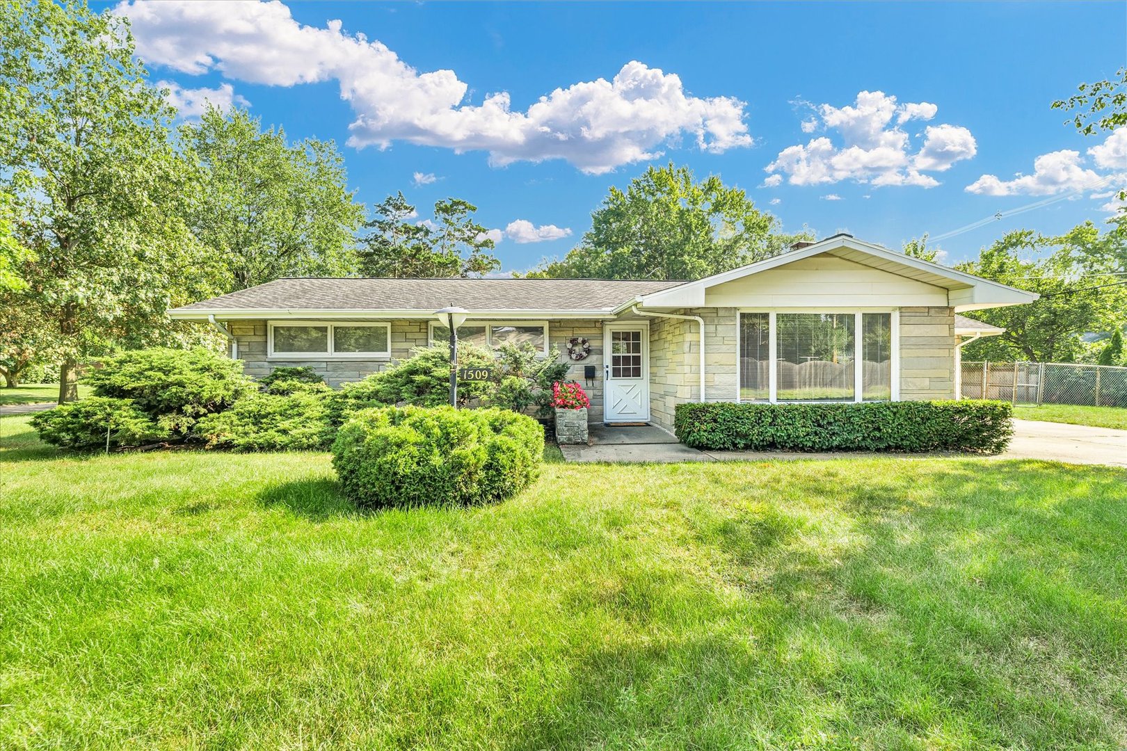 a front view of a house with garden