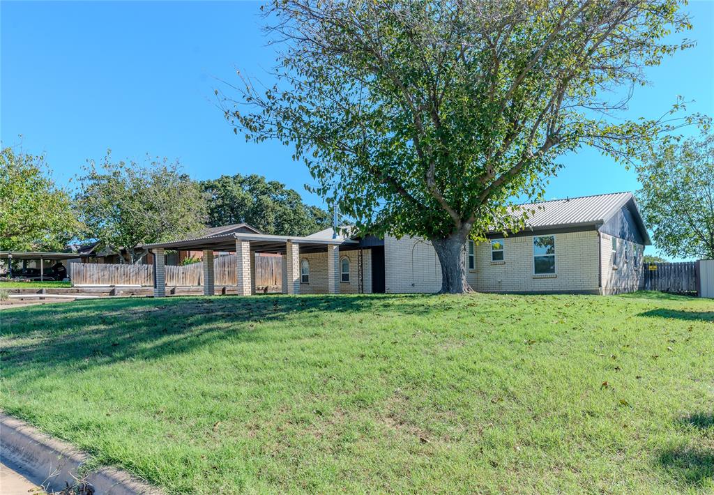 a house is sitting in middle od the grass