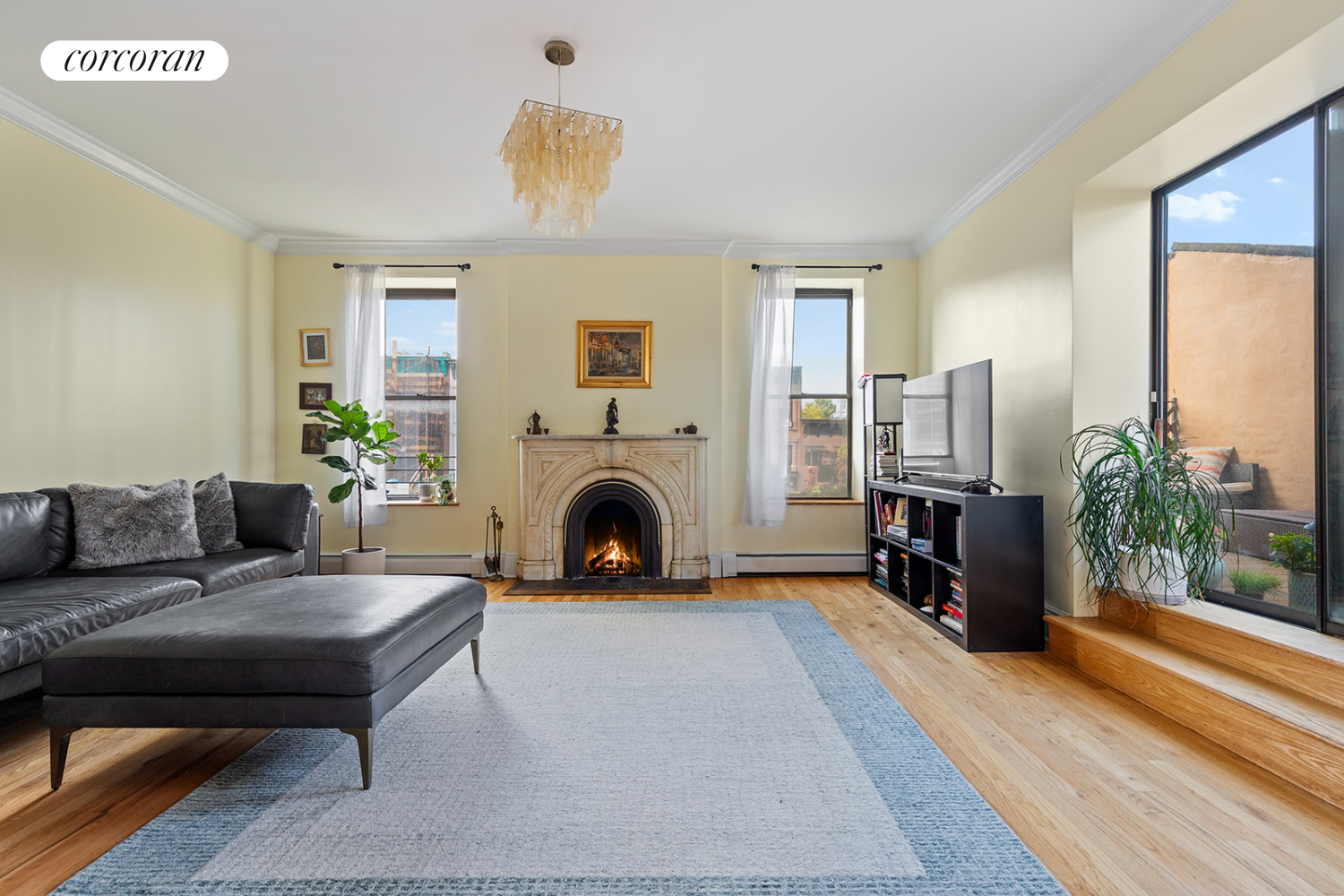 a living room with furniture a fireplace and a potted plant