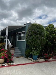 a view of a house with potted plants