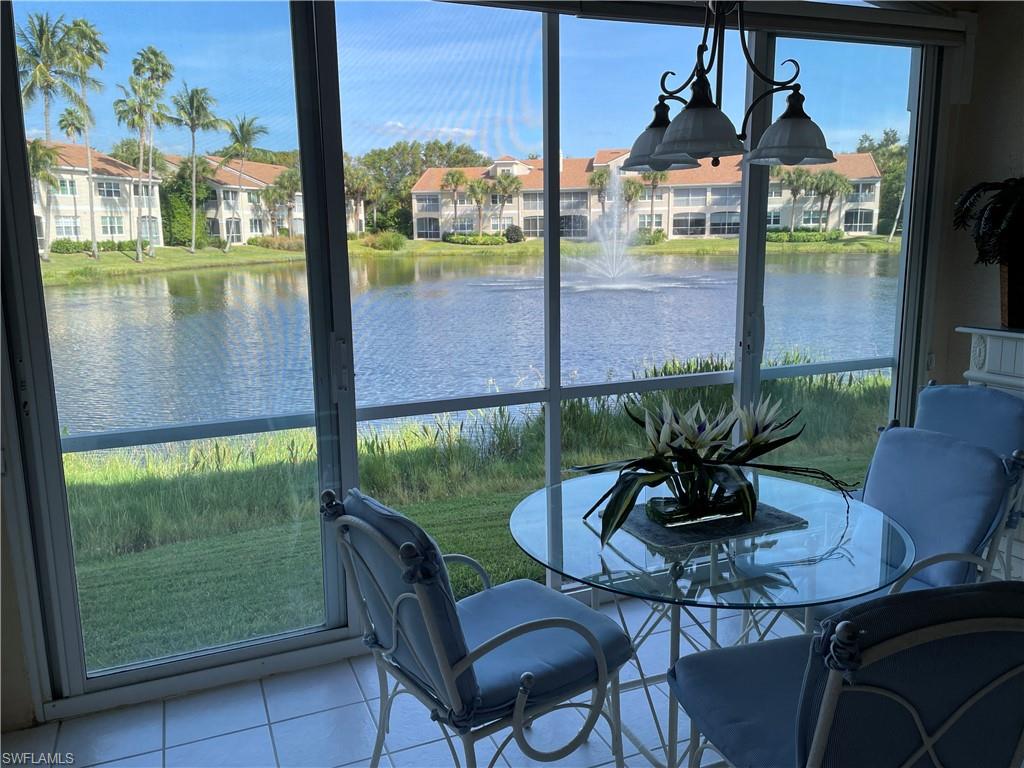 a dining room with furniture and garden view