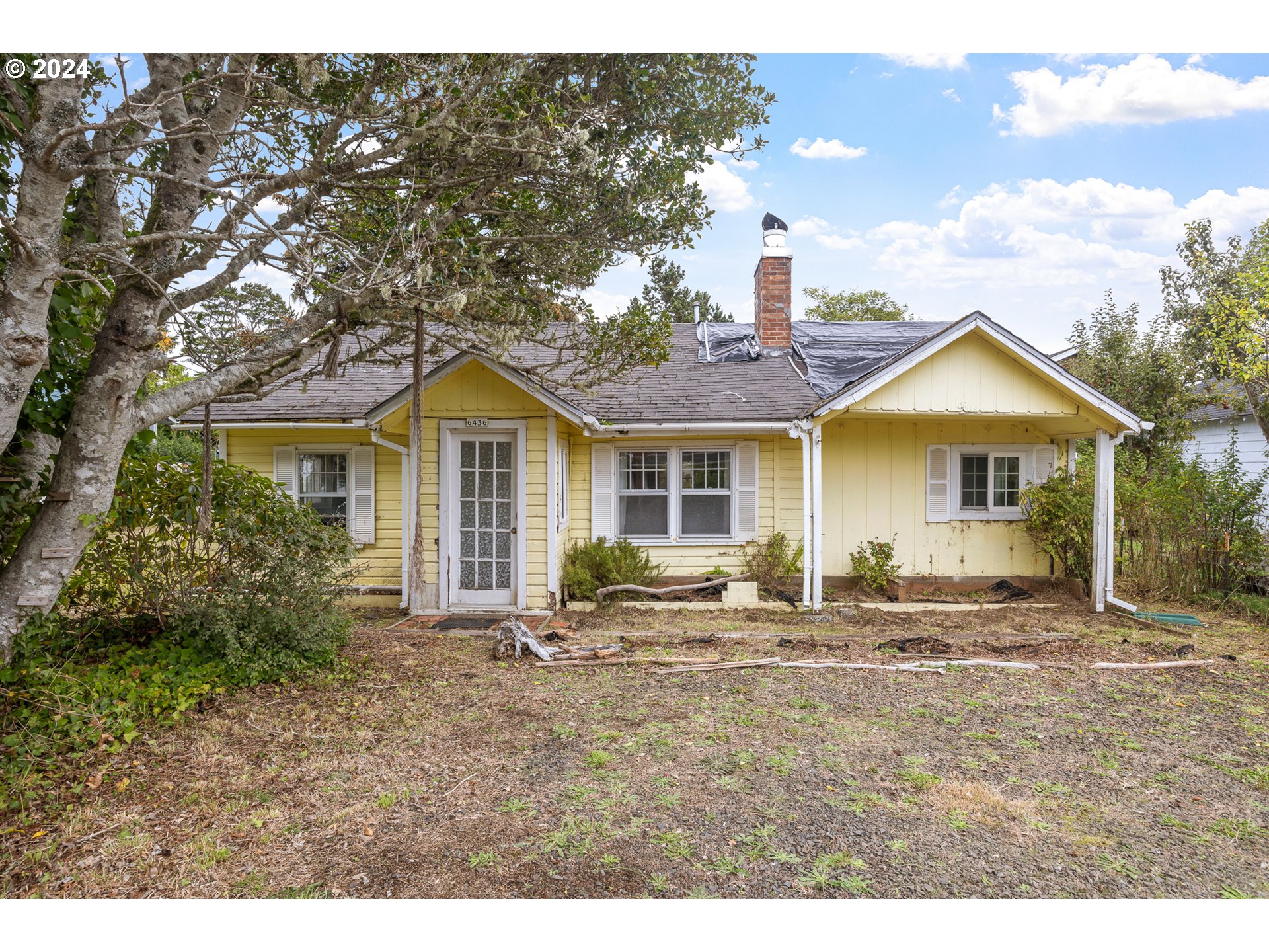 a front view of house with yard outdoor seating and barbeque oven