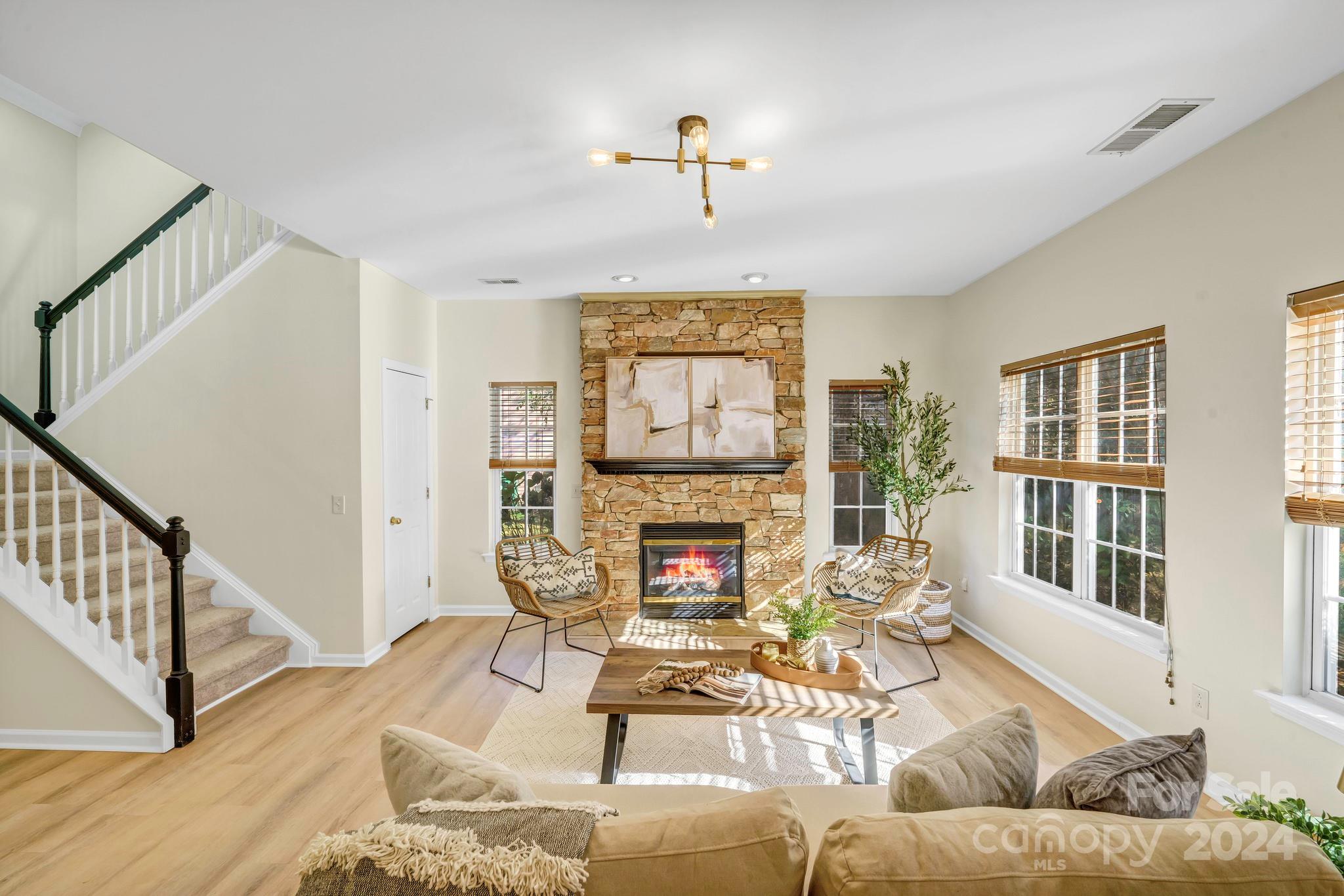 a living room with furniture fireplace and a window