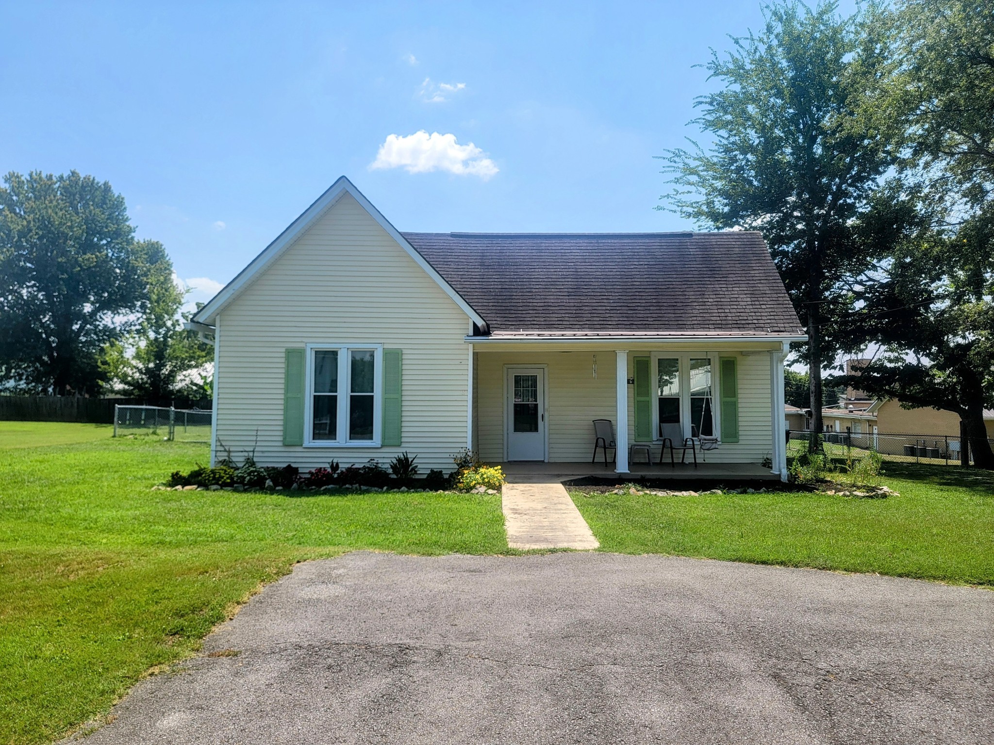 a front view of house with yard and green space