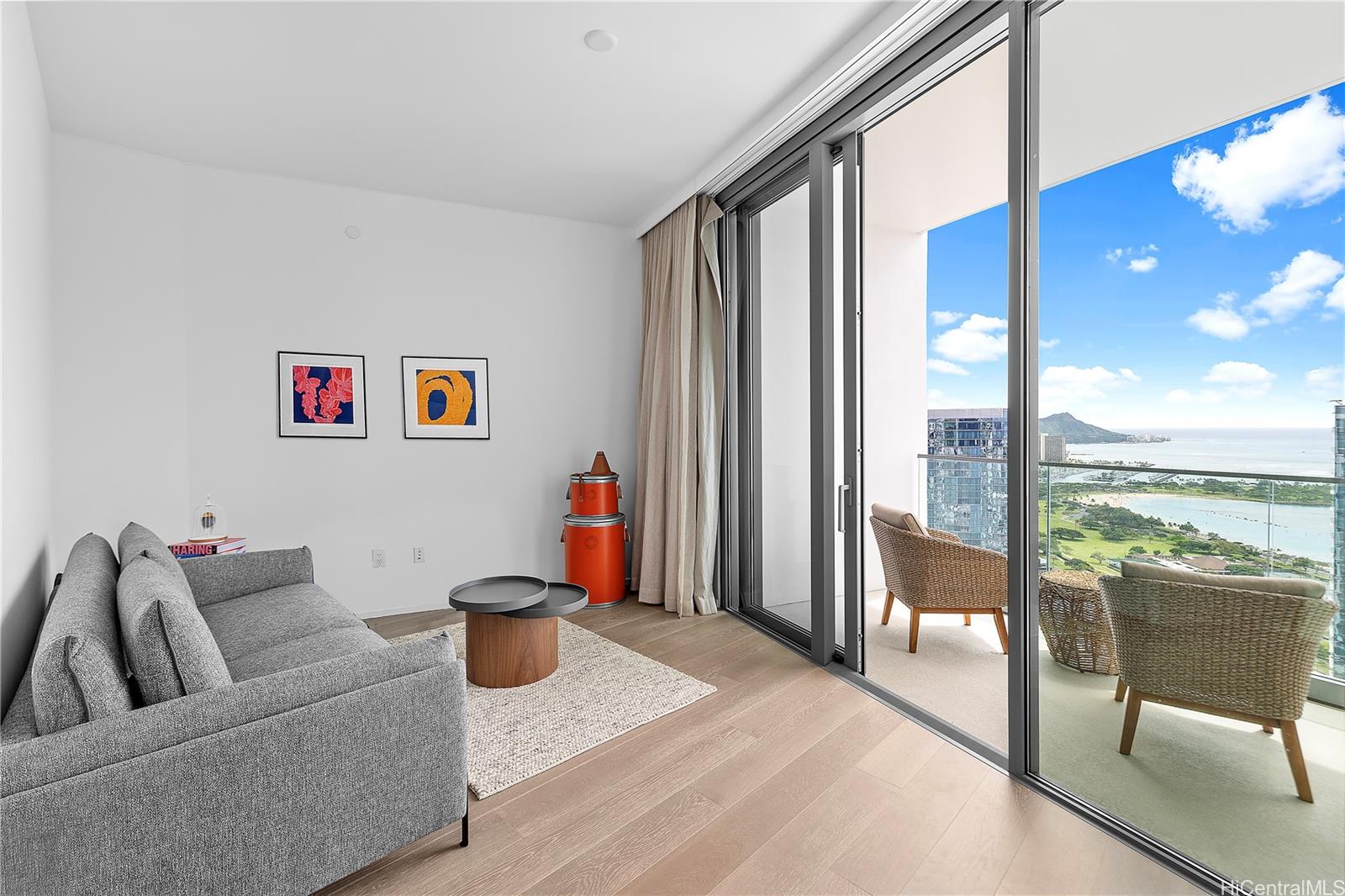 a living room with furniture and a floor to ceiling window