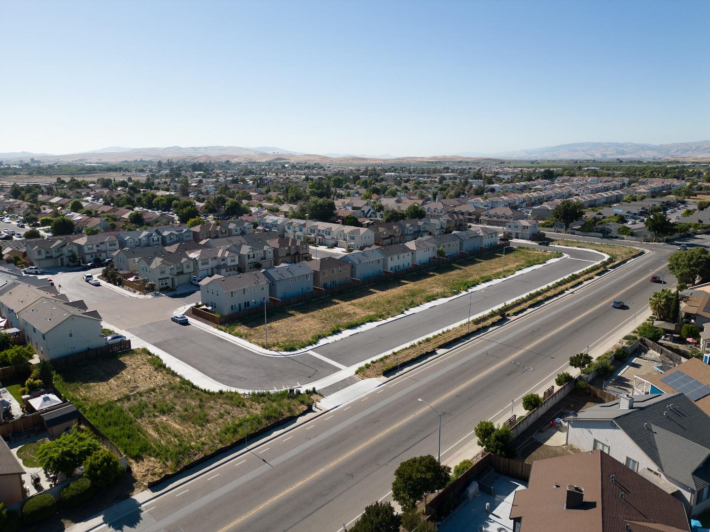 an aerial view of residential houses with yard