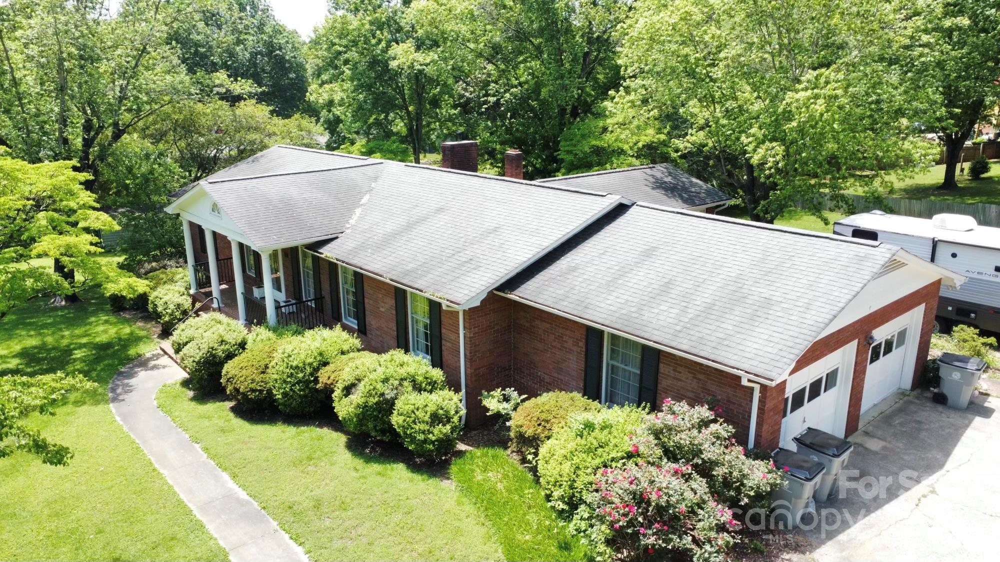 a aerial view of a house with a yard potted plants