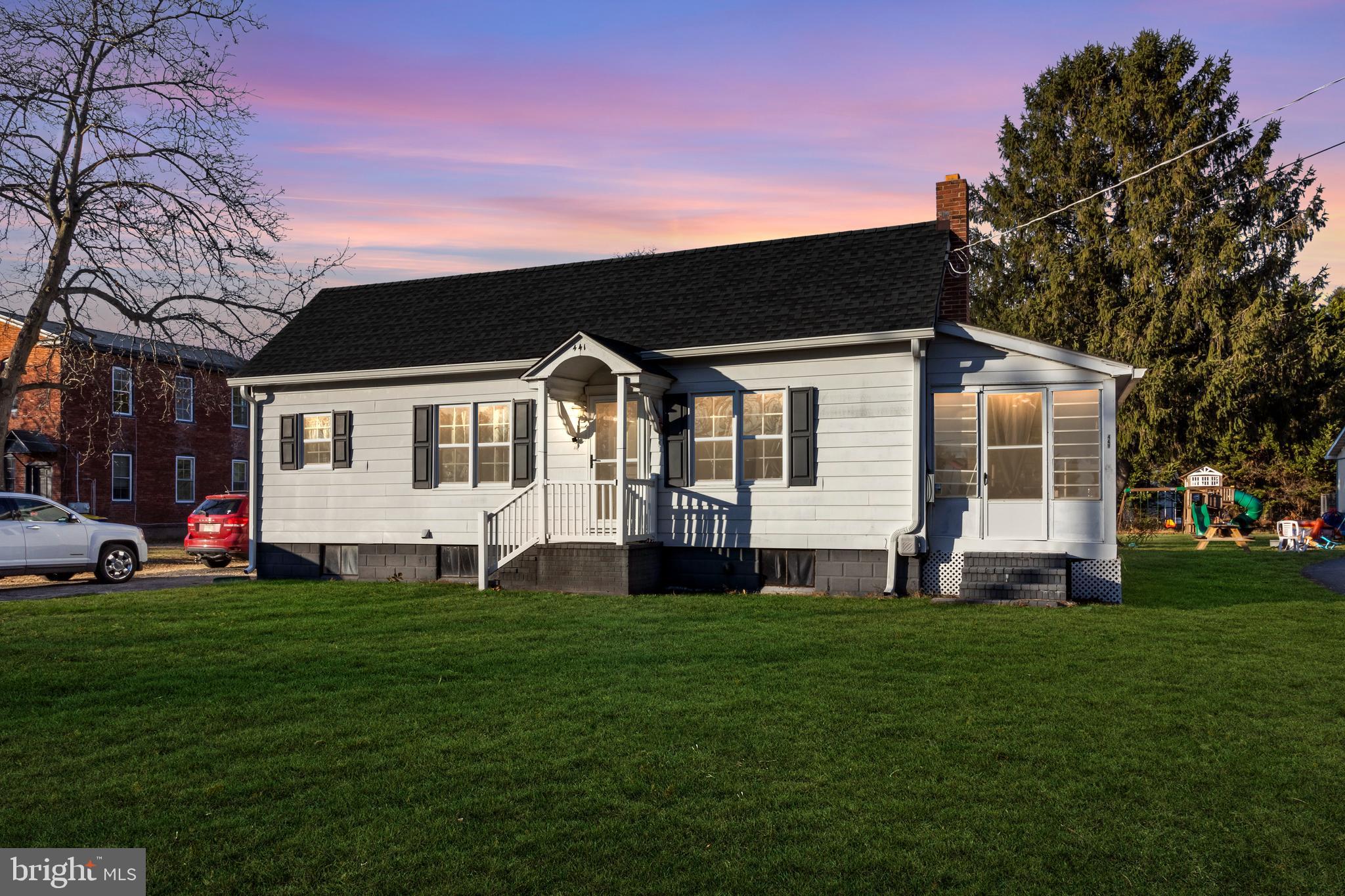 a front view of house with yard and green space