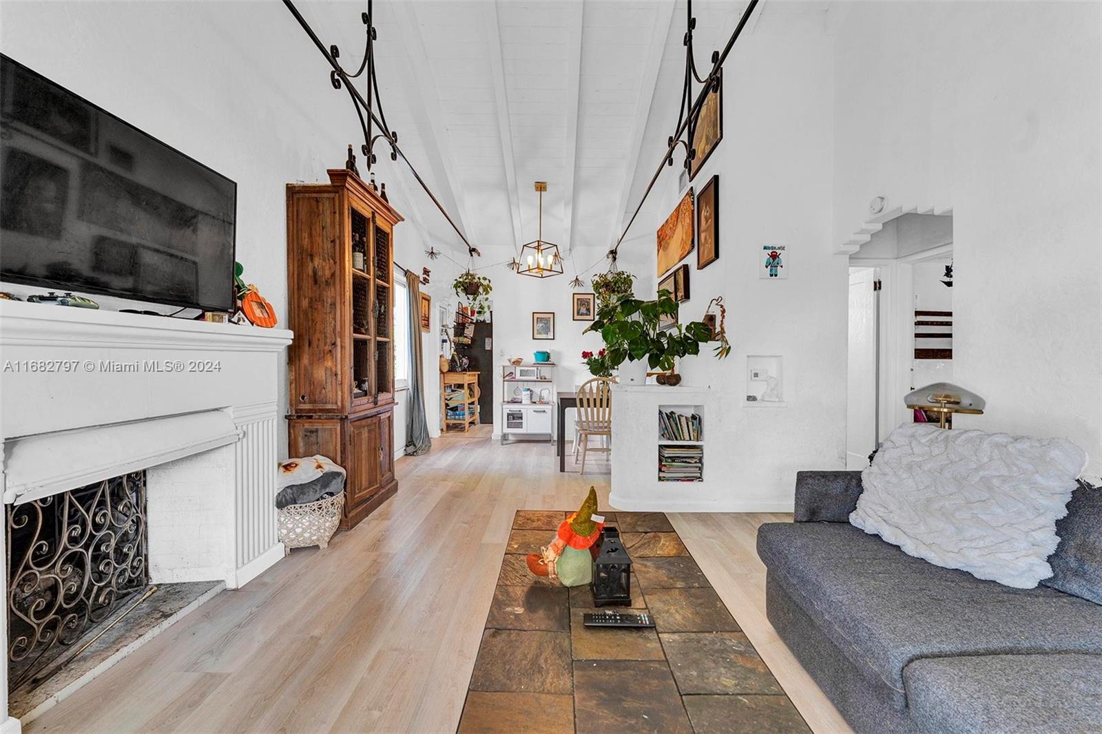 a living room with furniture fireplace and flat screen tv