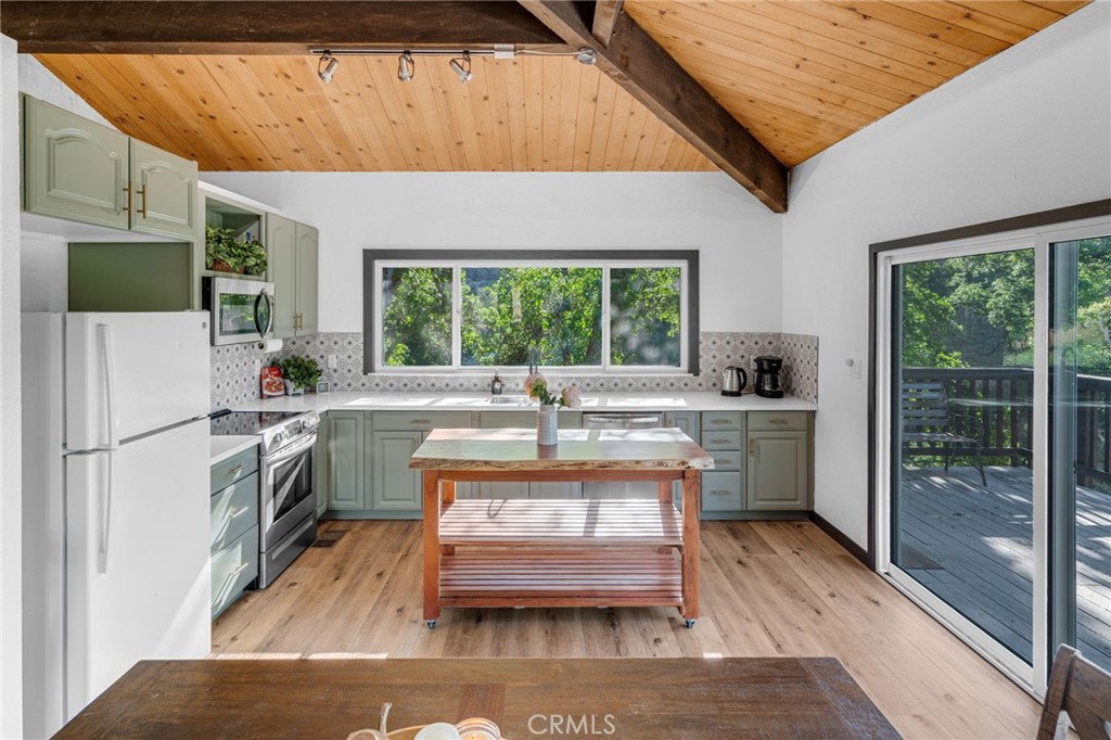 a kitchen with a stove a refrigerator and a sink