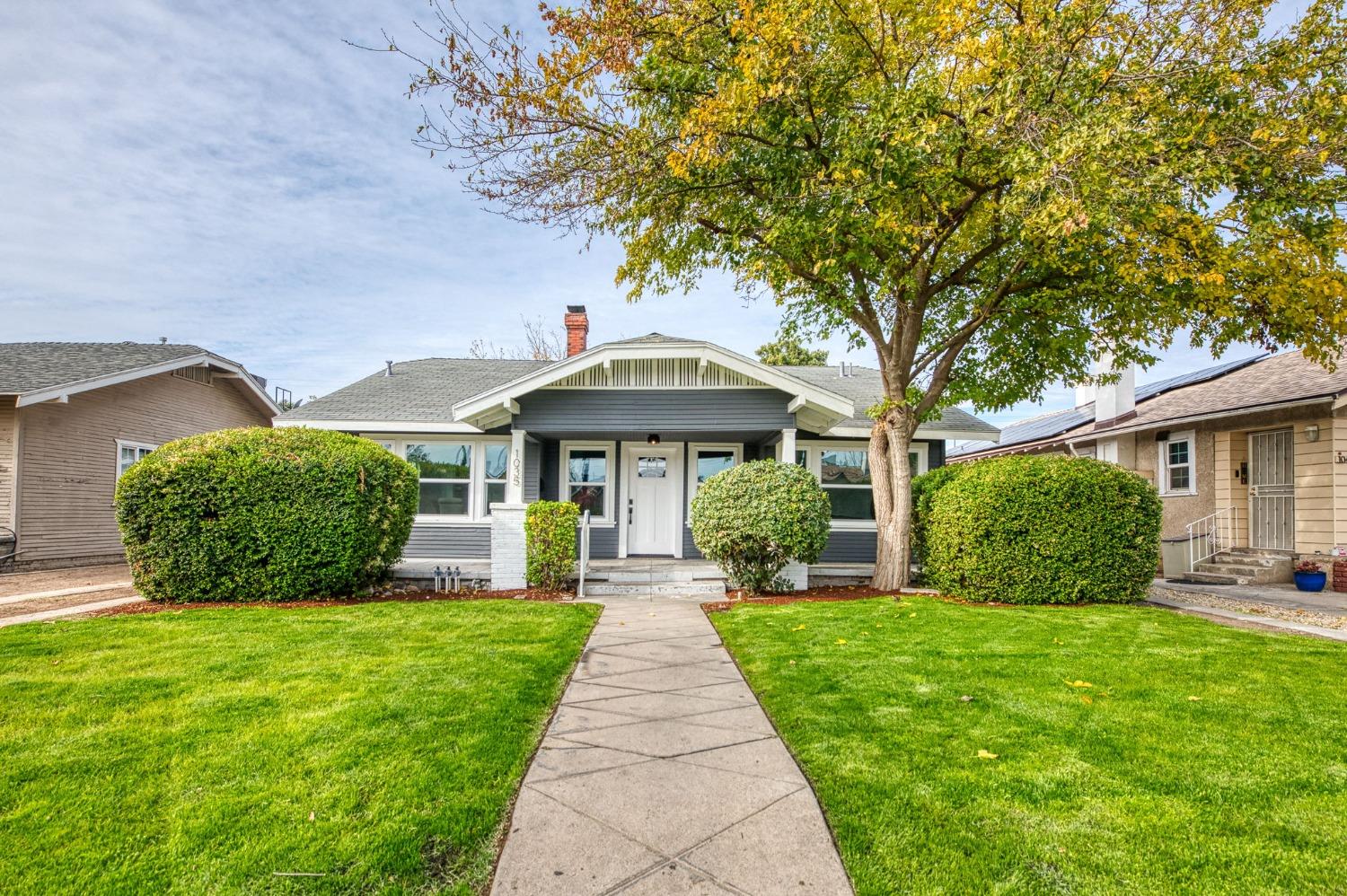 a front view of a house with garden