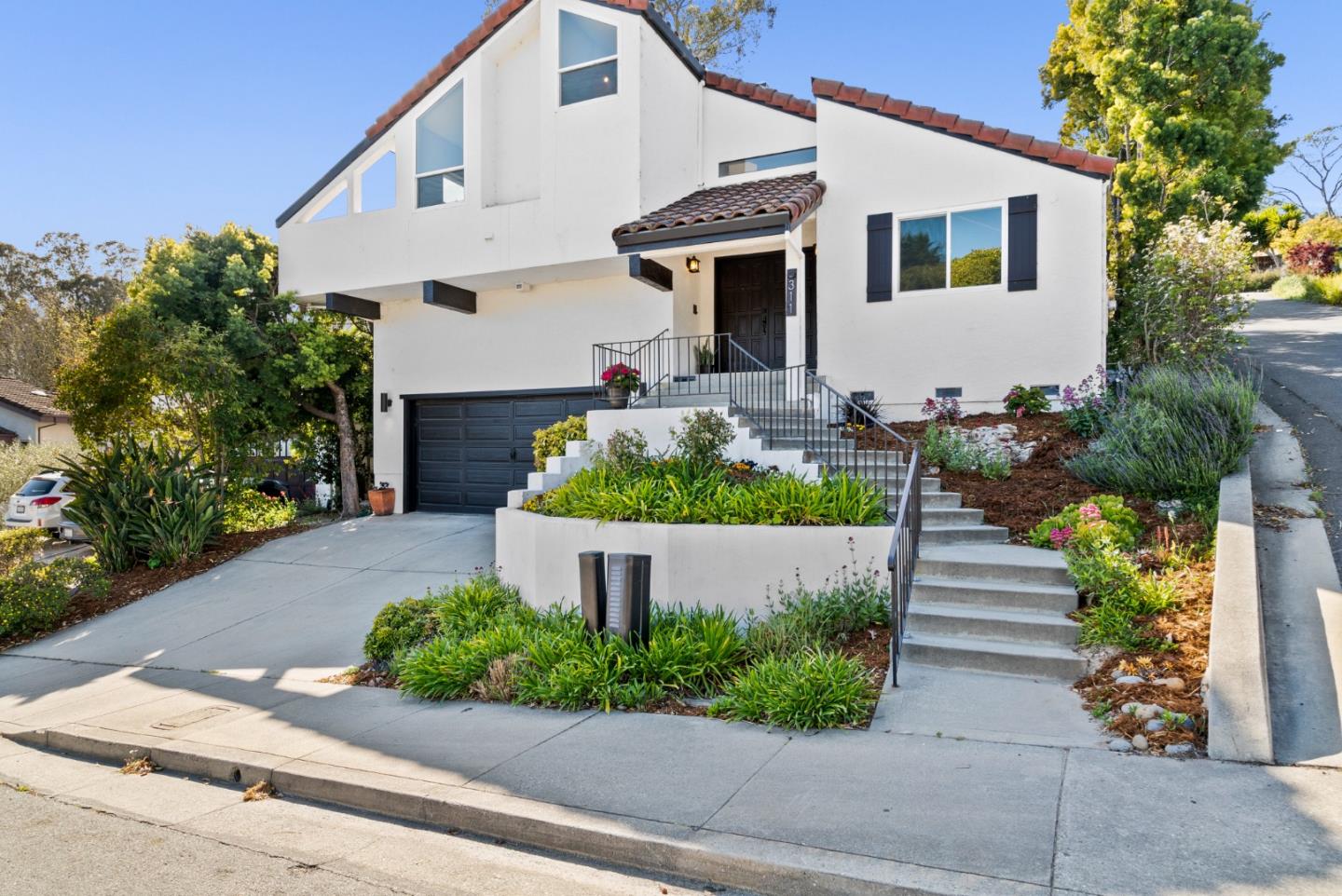 a front view of a house with a garden