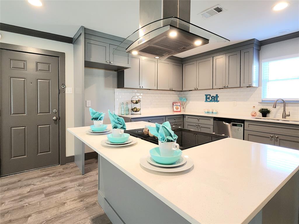 a kitchen with a sink a stove and cabinets