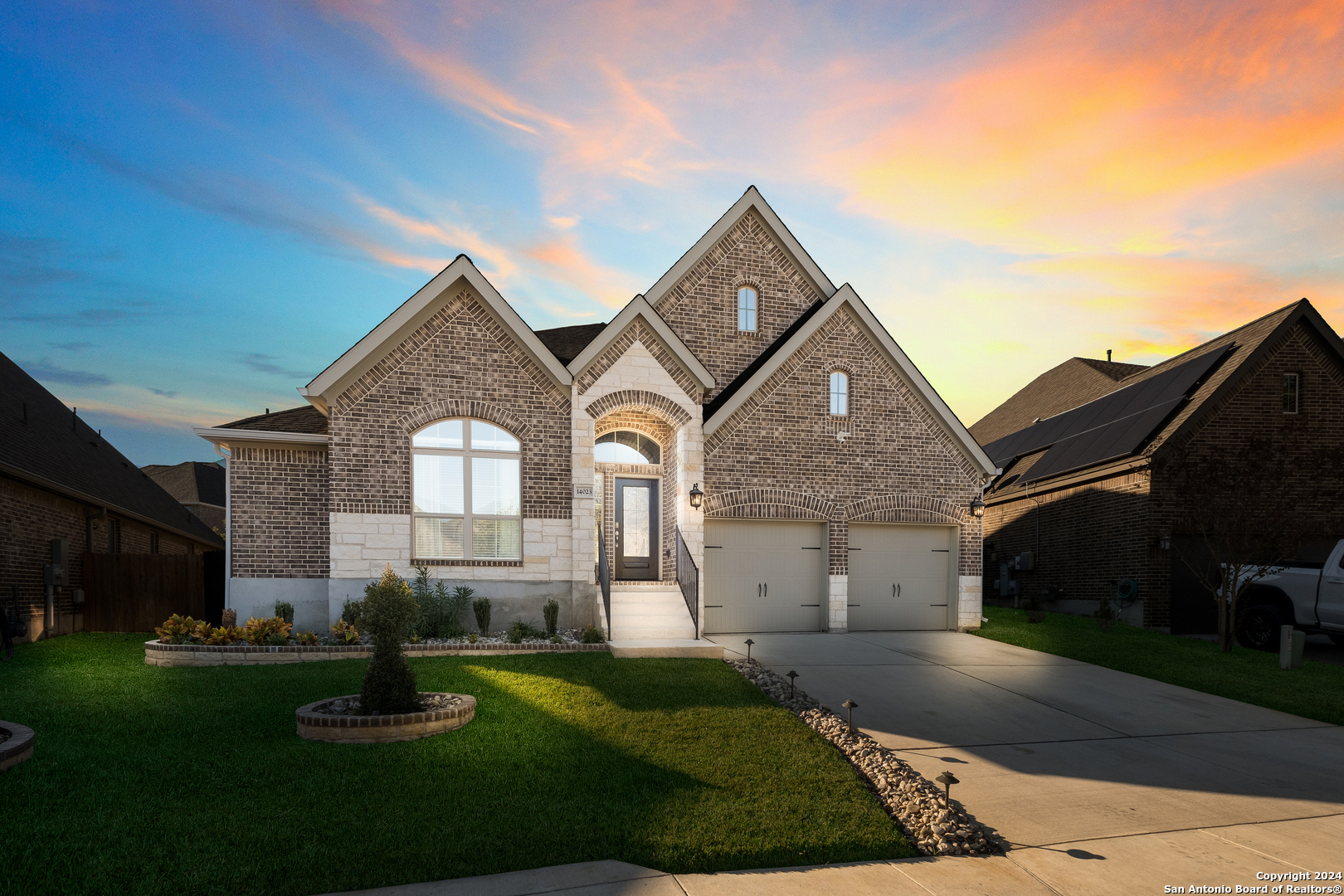 a front view of a house with a yard and garage