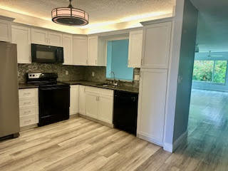 a kitchen with a sink stainless steel appliances and cabinets