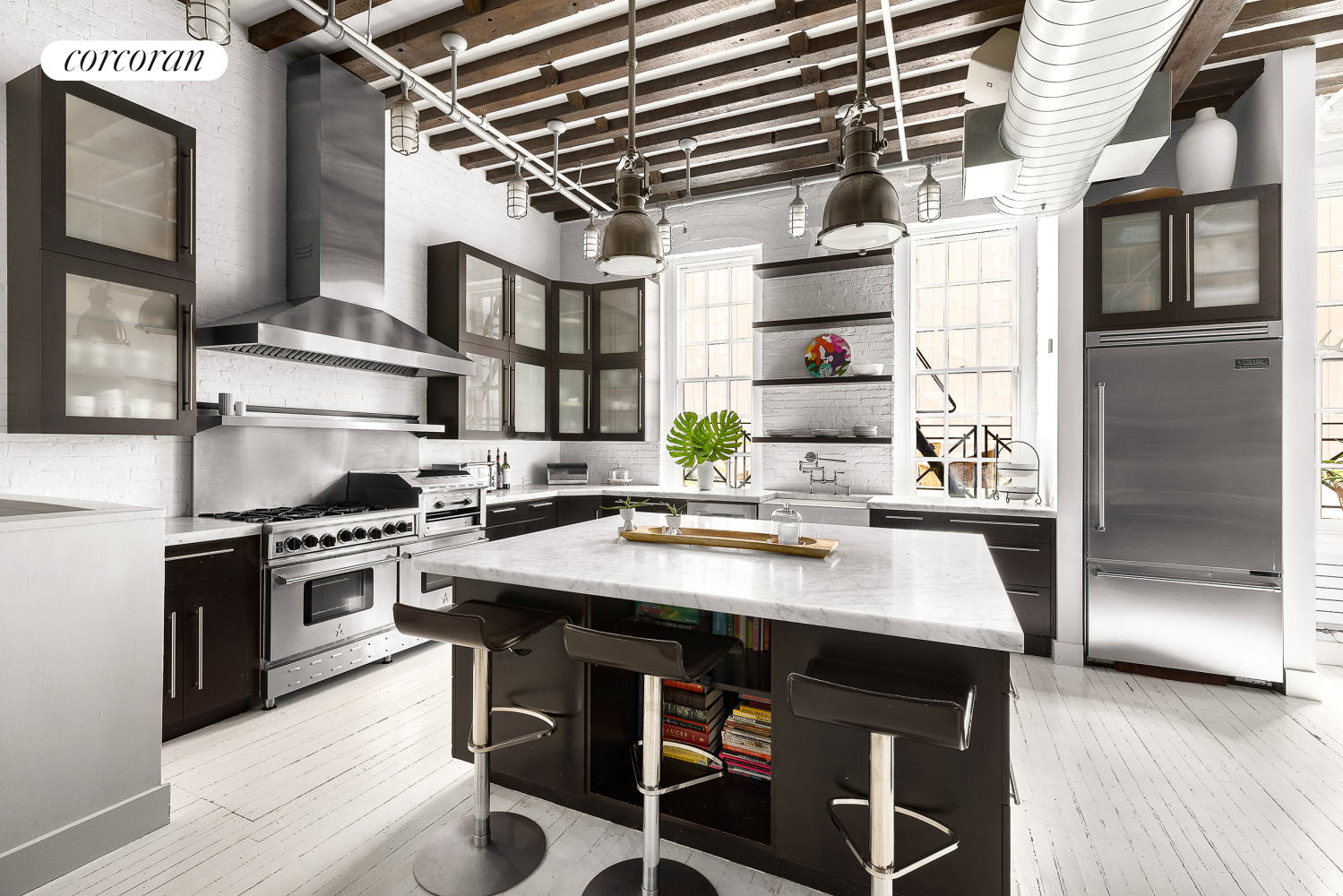 a kitchen with stainless steel appliances granite countertop a stove and a refrigerator