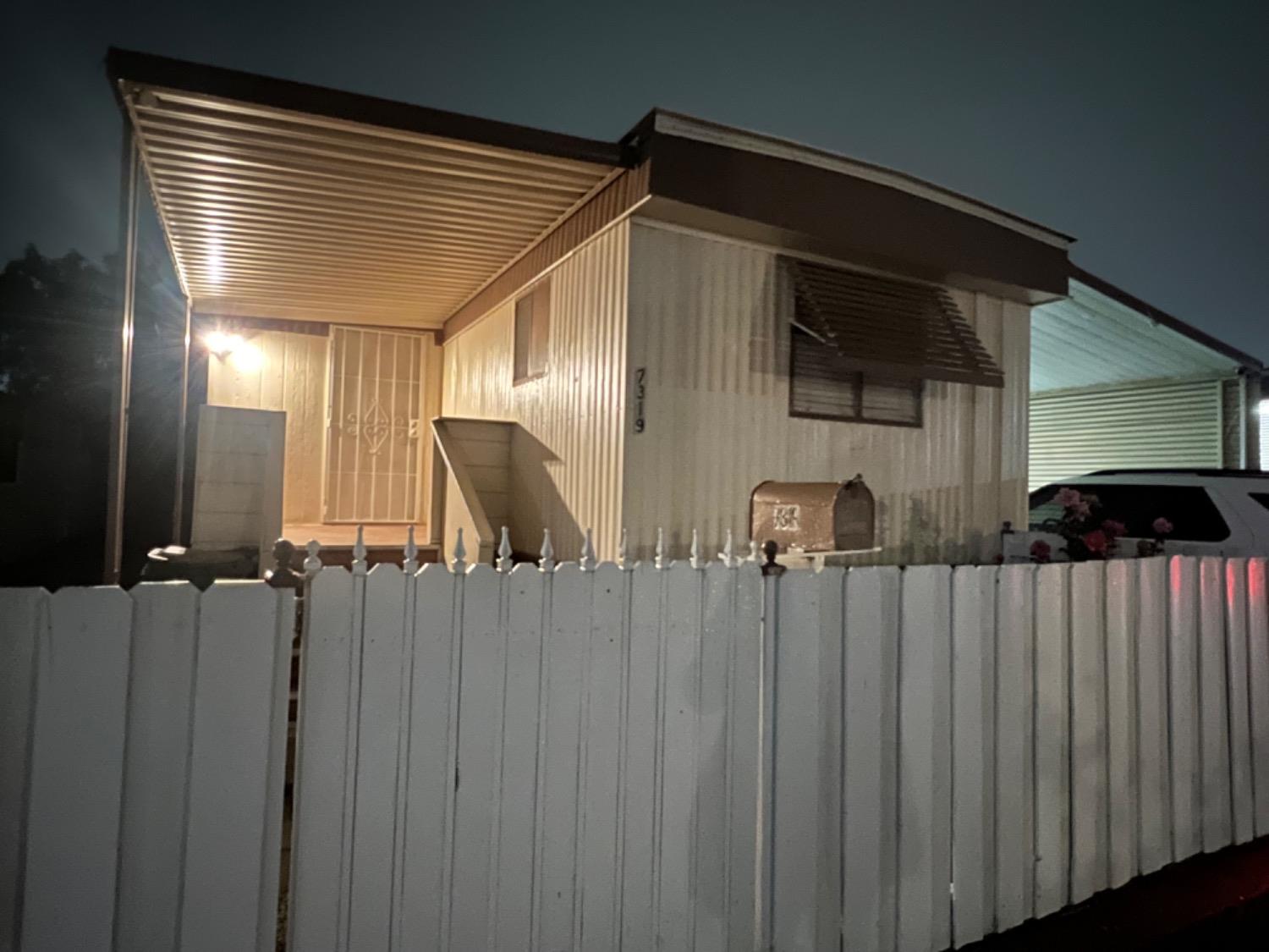 a view of a house with wooden fence