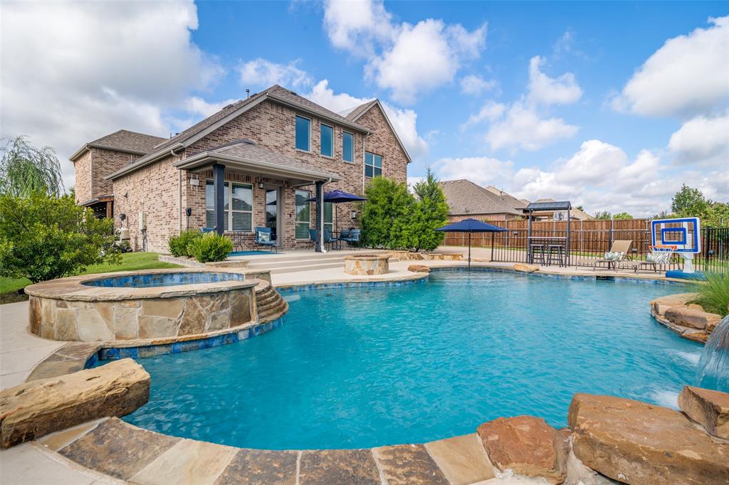 a front view of a house with swimming pool having outdoor seating