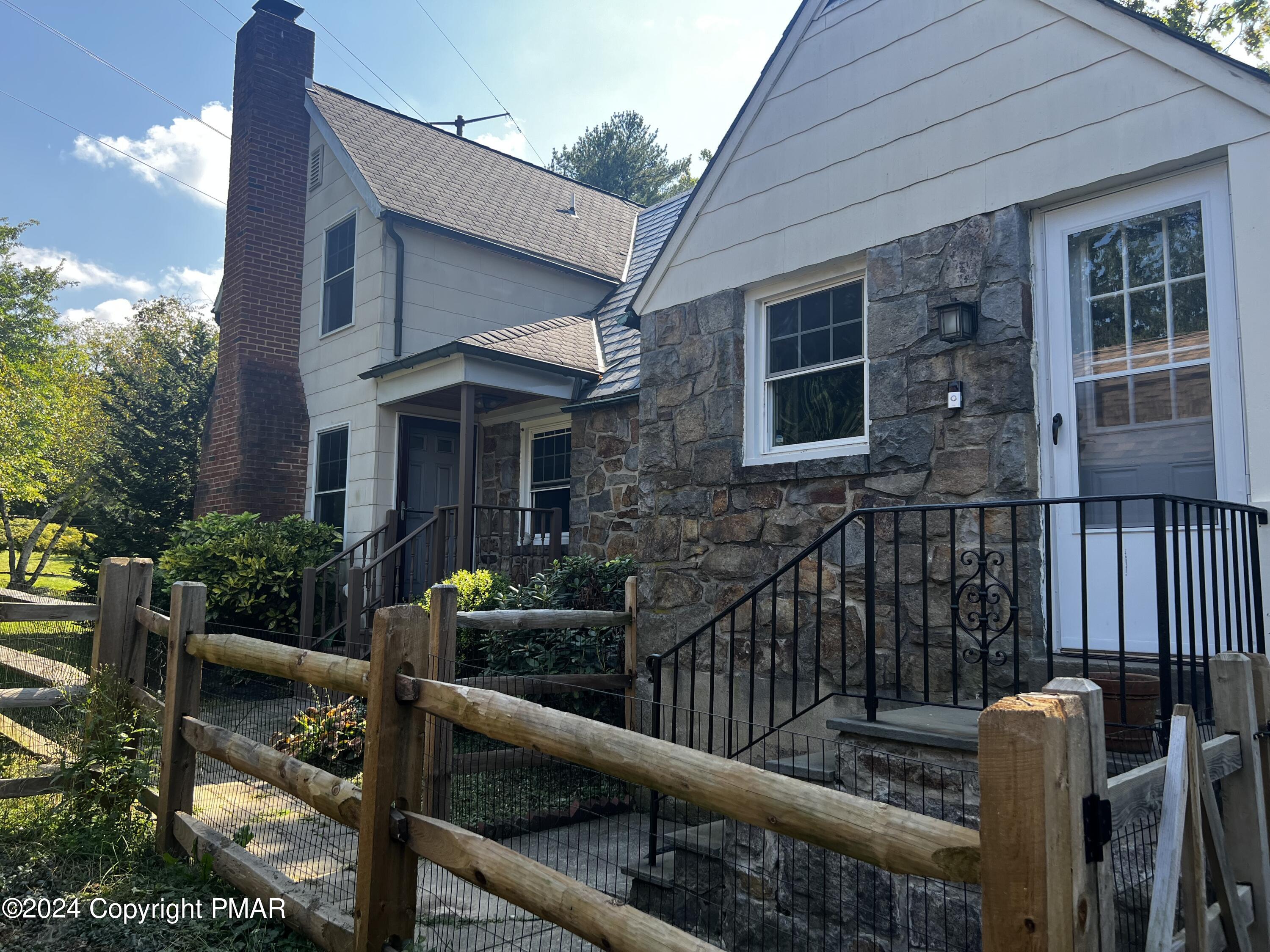 a view of house with outdoor seating area