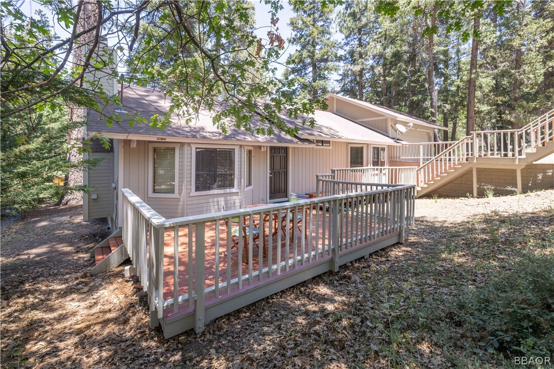 a view of house with a wooden deck