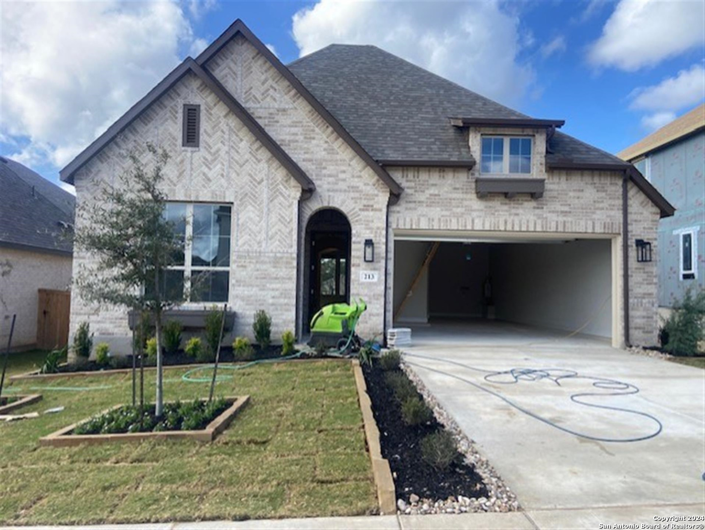 a front view of a house with garden