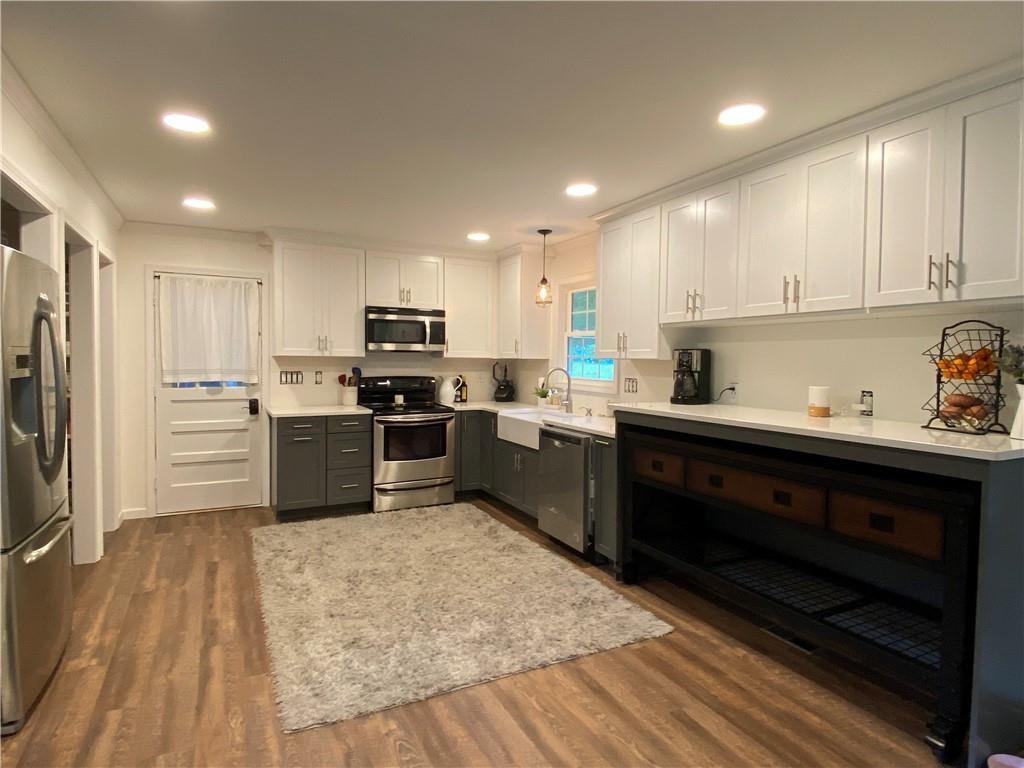 a kitchen with a sink stainless steel appliances and counter space