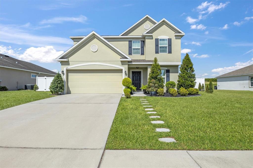 a front view of a house with a yard