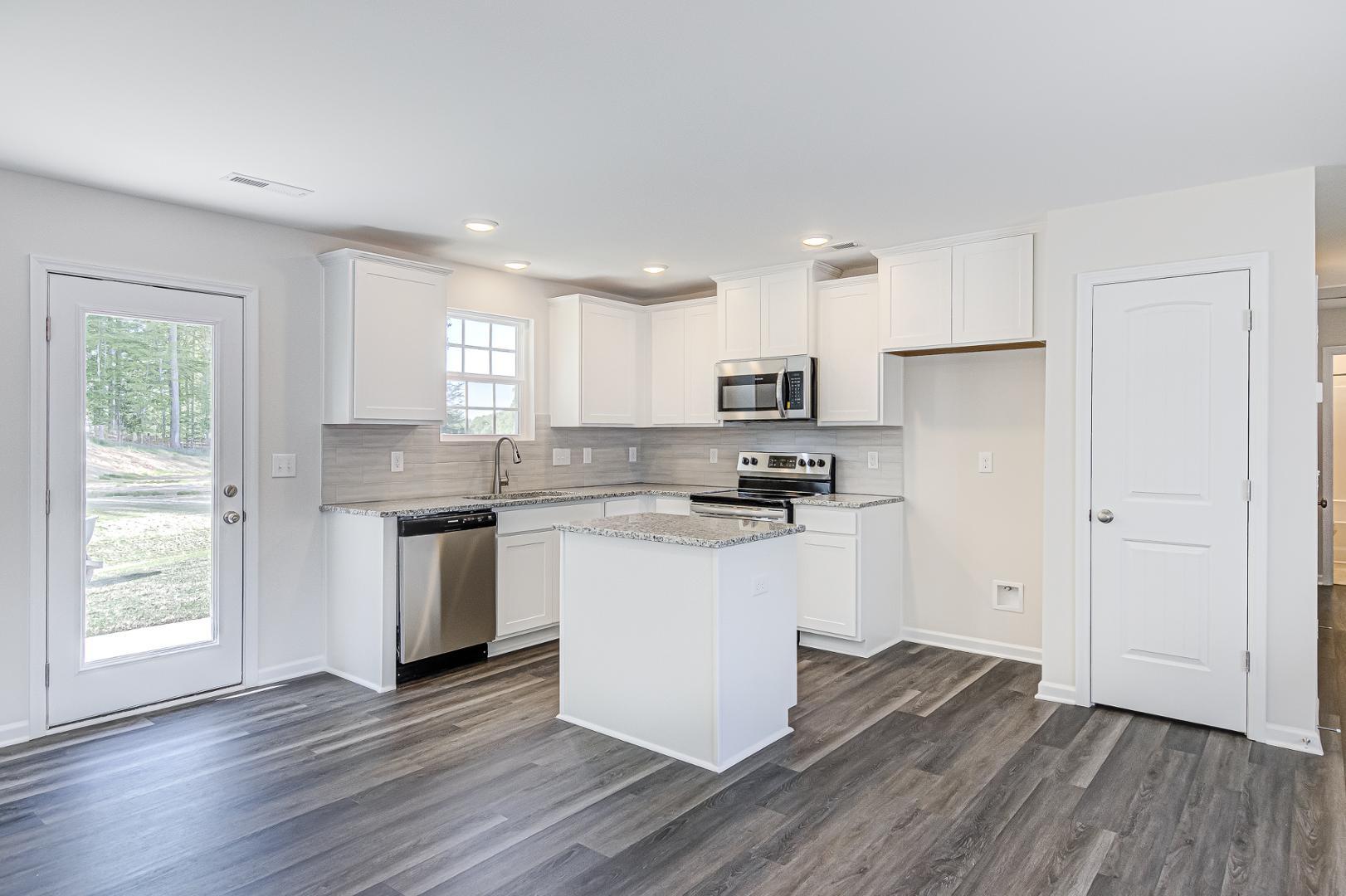 a kitchen with wooden floors and white appliances