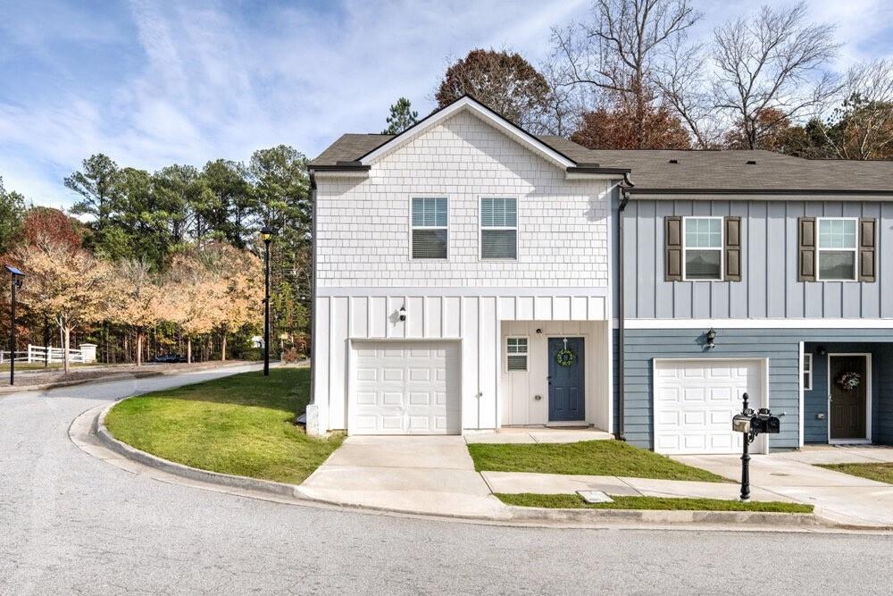 a front view of a house with a yard and garage