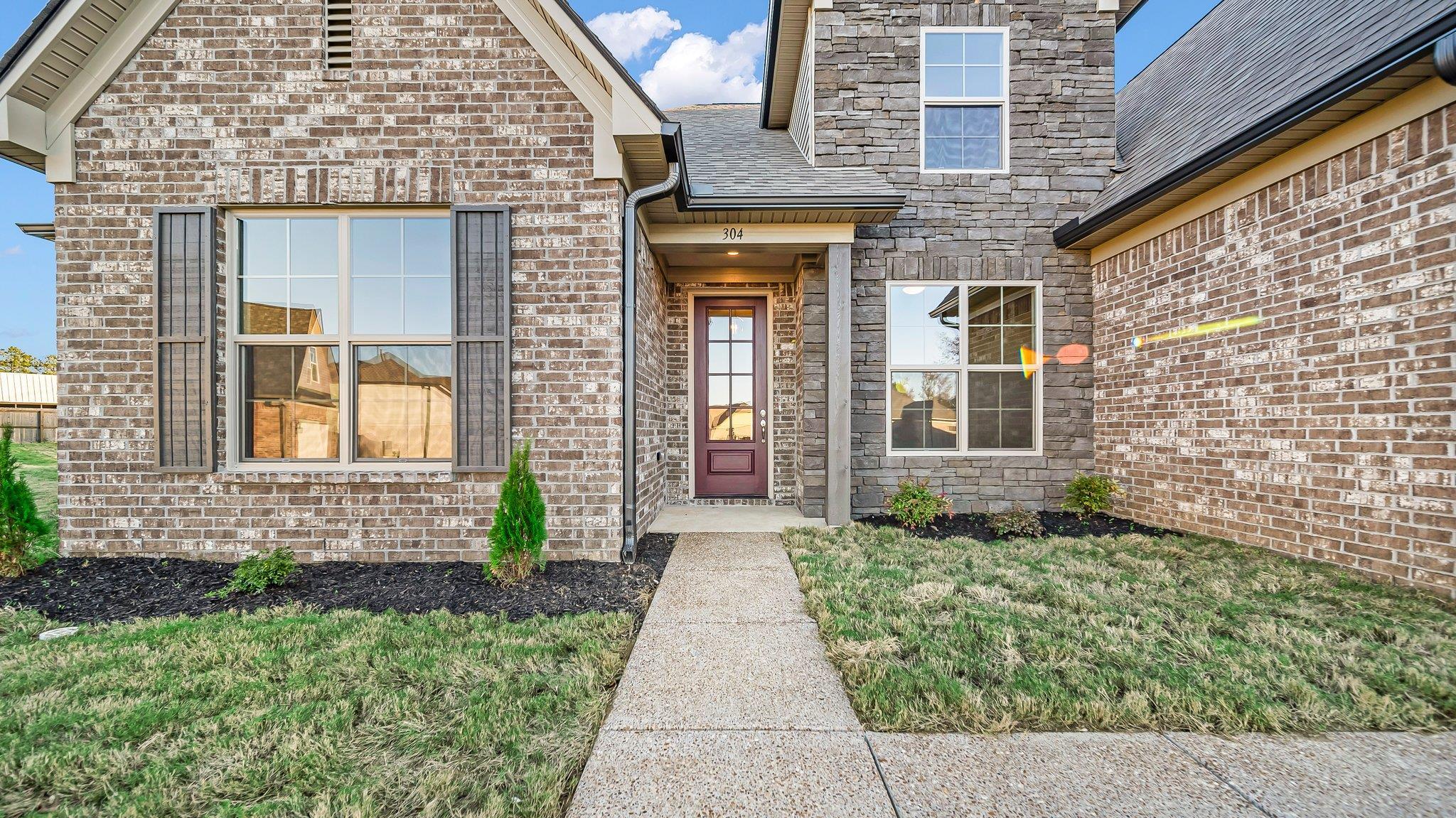 front view of a brick house with a large door