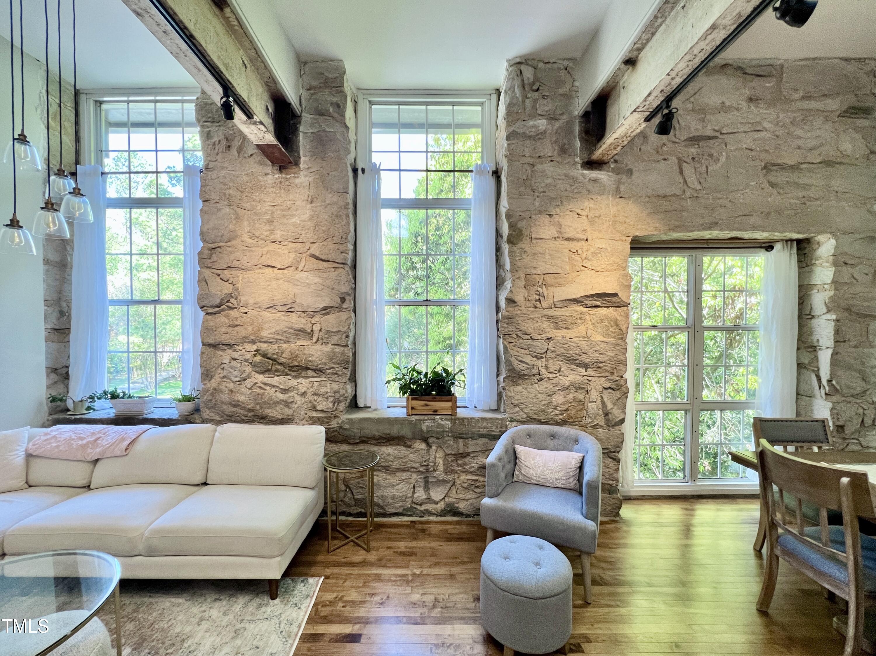 a living room with furniture and a floor to ceiling window