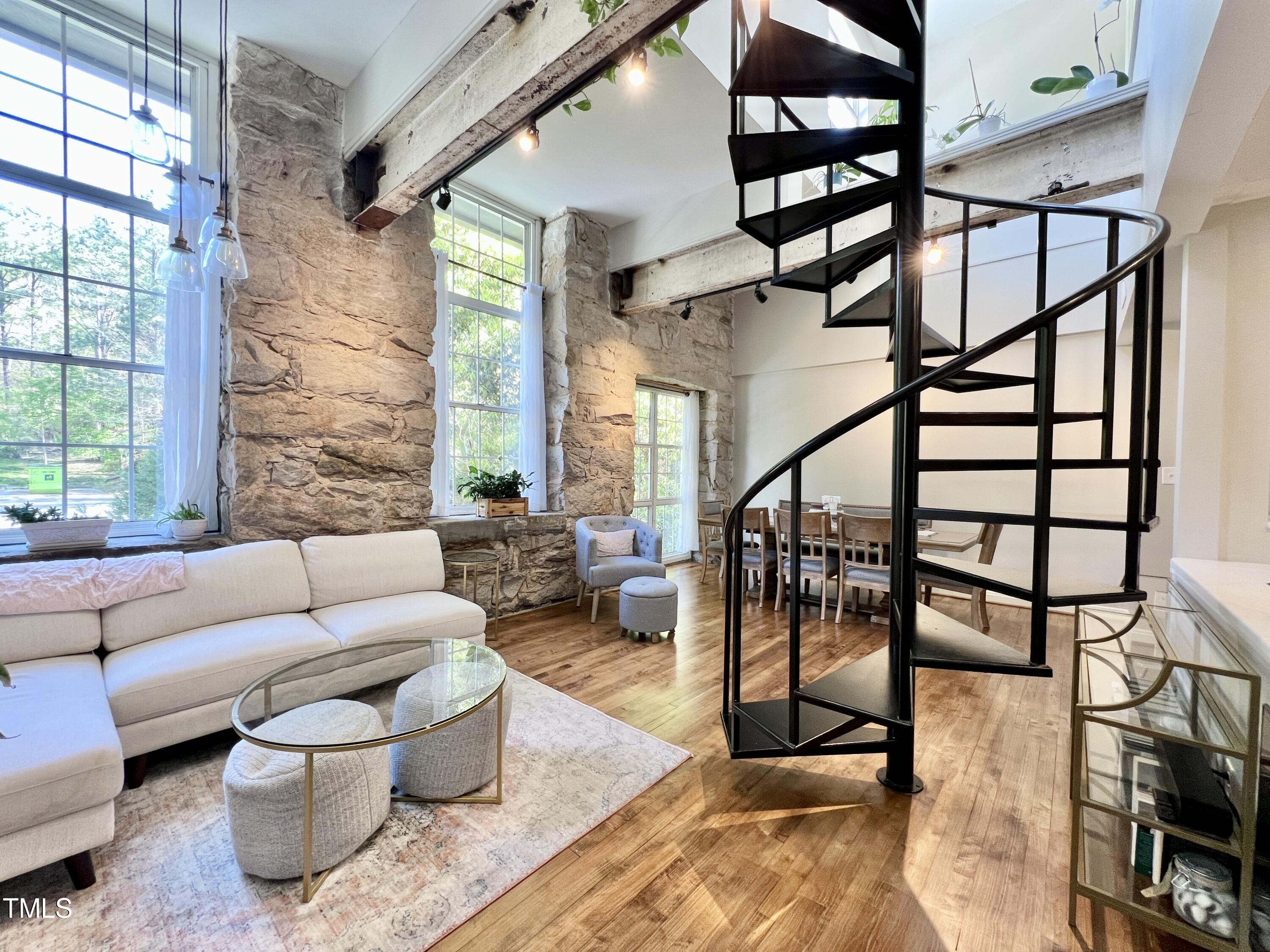 a living room with furniture and a potted plant on a table