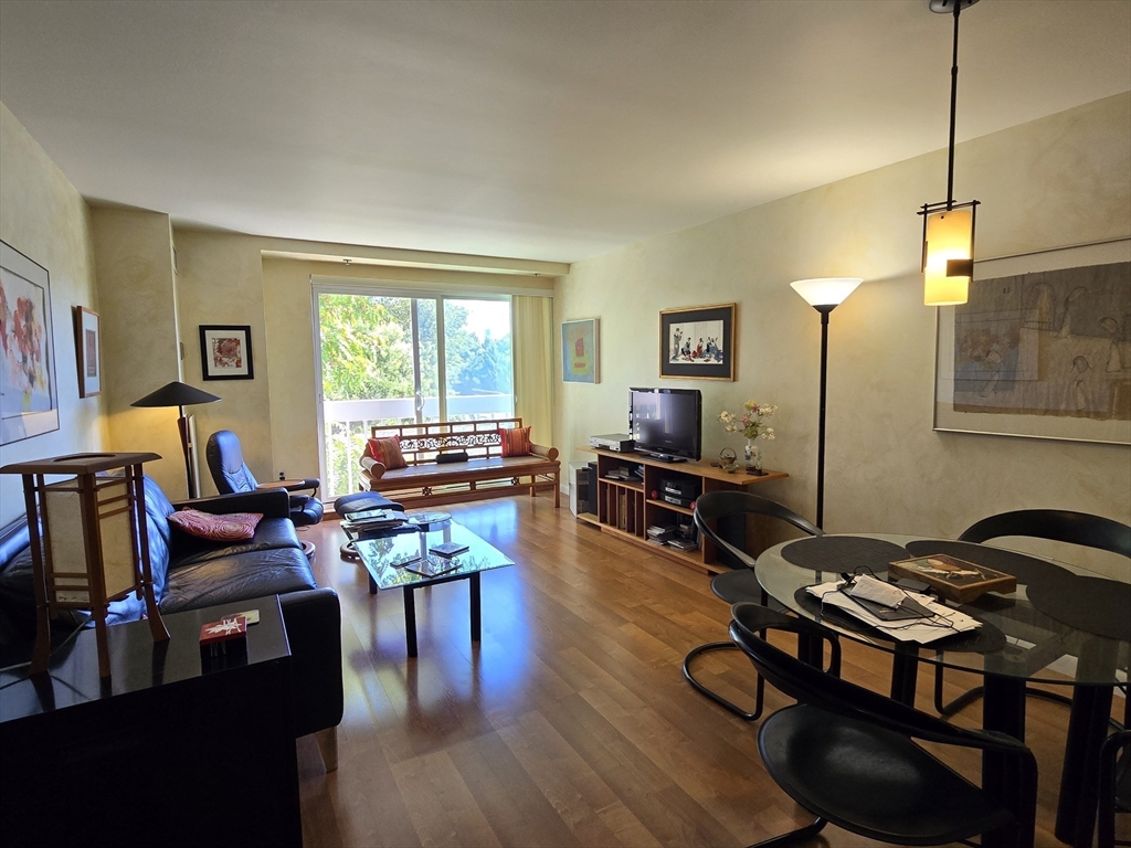 a living room with furniture a piano and a flat screen tv