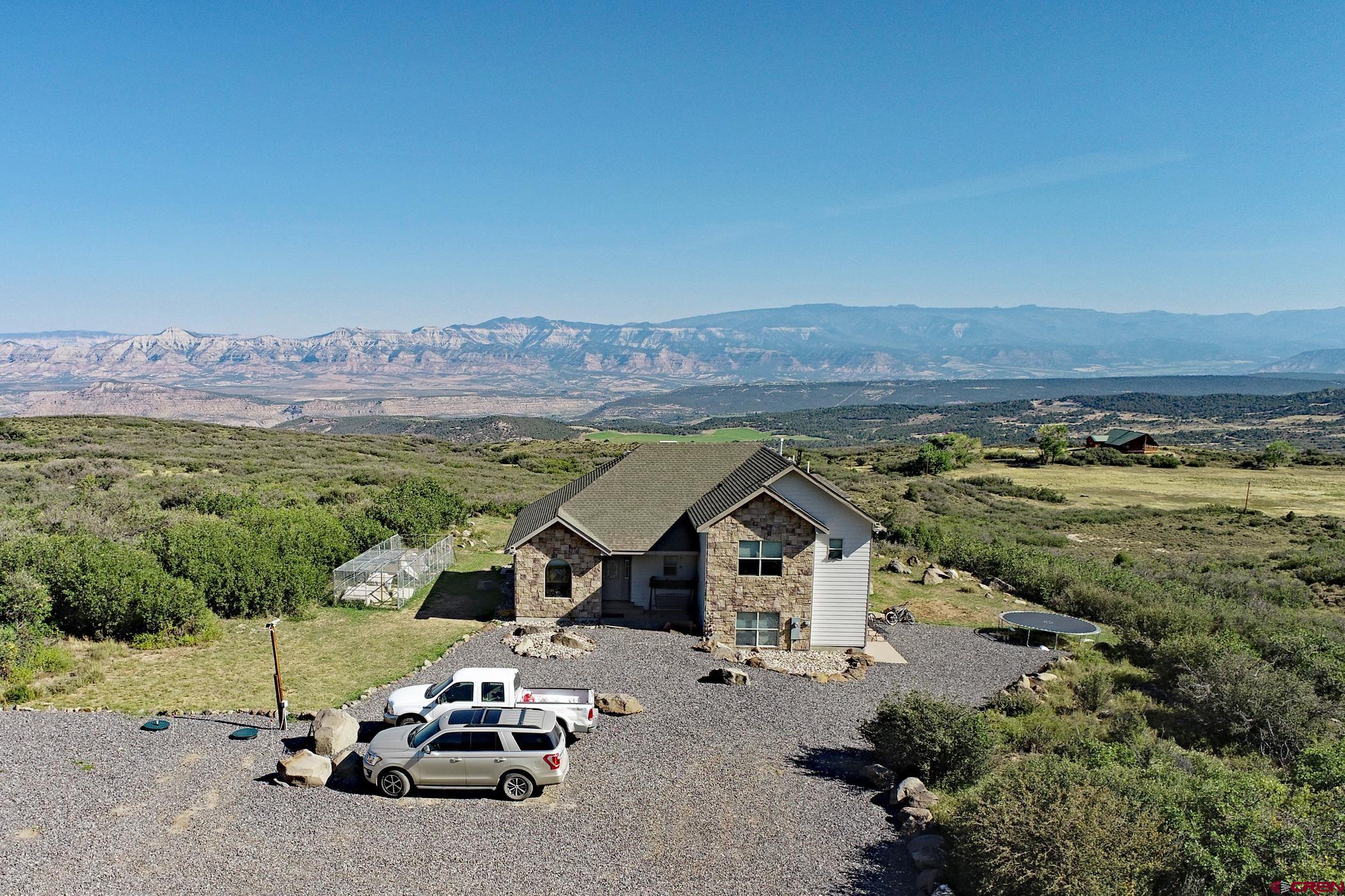 an aerial view of a house with mountain view